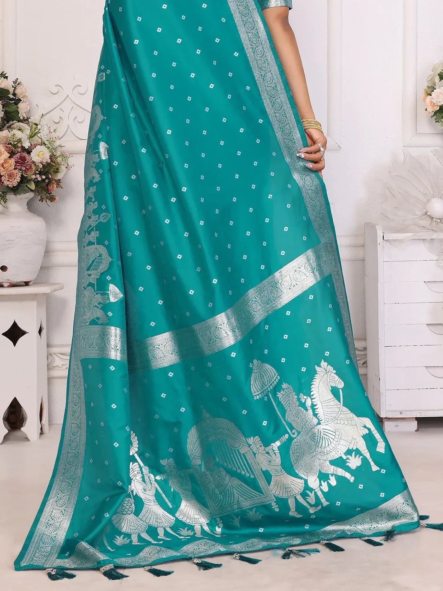 Teal saree with silver horse and warrior motifs, perfect for ethnic occasions