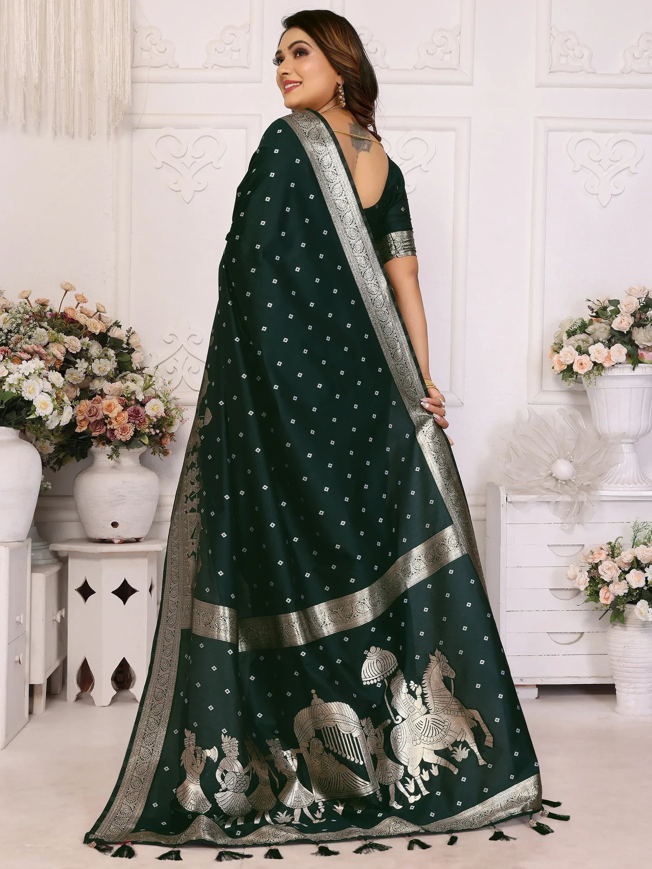 Elegant dark green saree with silver horse motifs and intricate border, perfect for ethnic occasions.