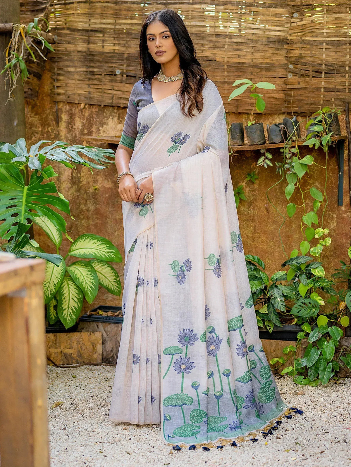Elegant floral printed saree with purple and green motifs, paired with a grey blouse, perfect for ethnic occasions.