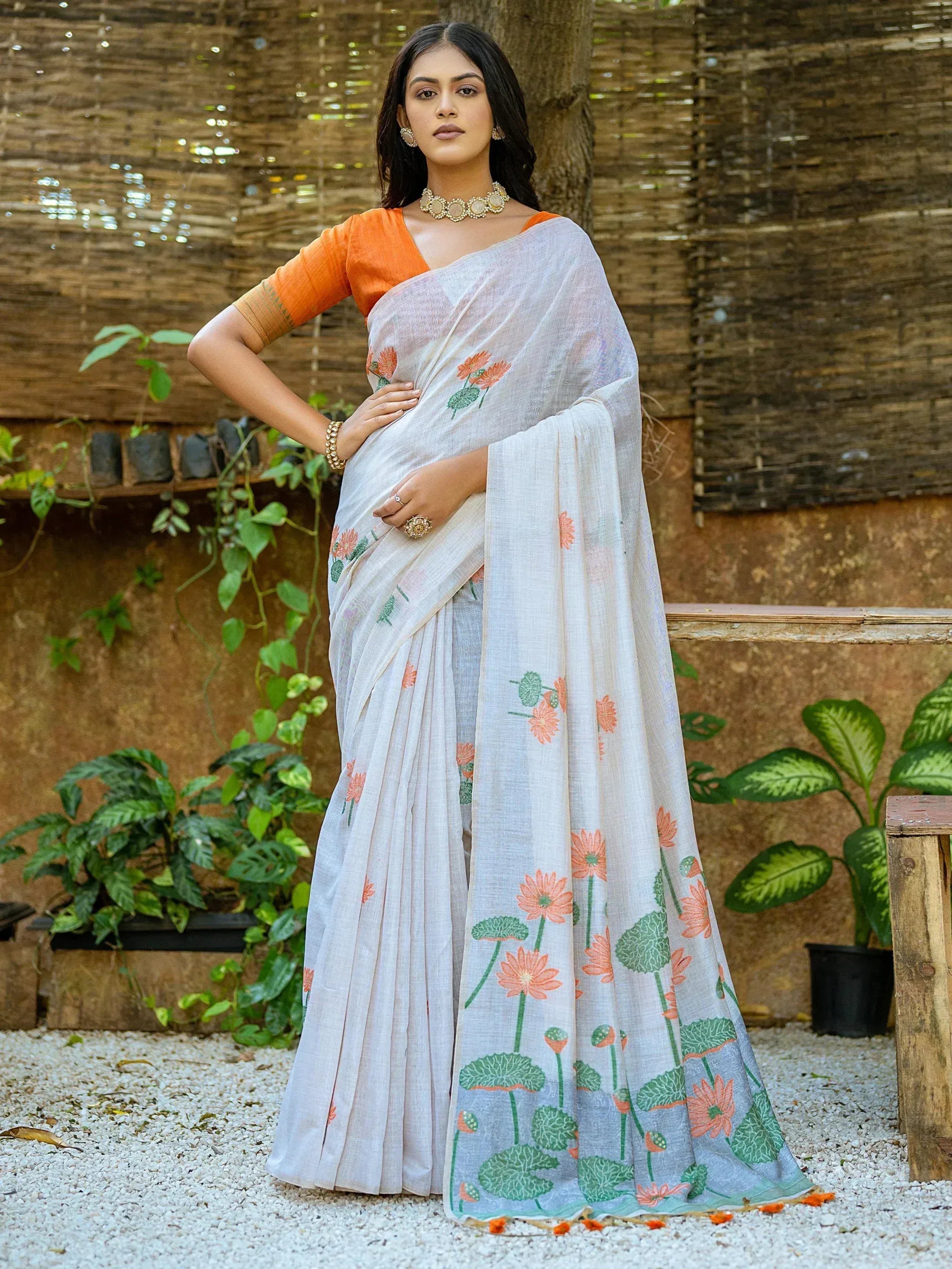White floral saree with orange blouse, perfect for ethnic wear occasions