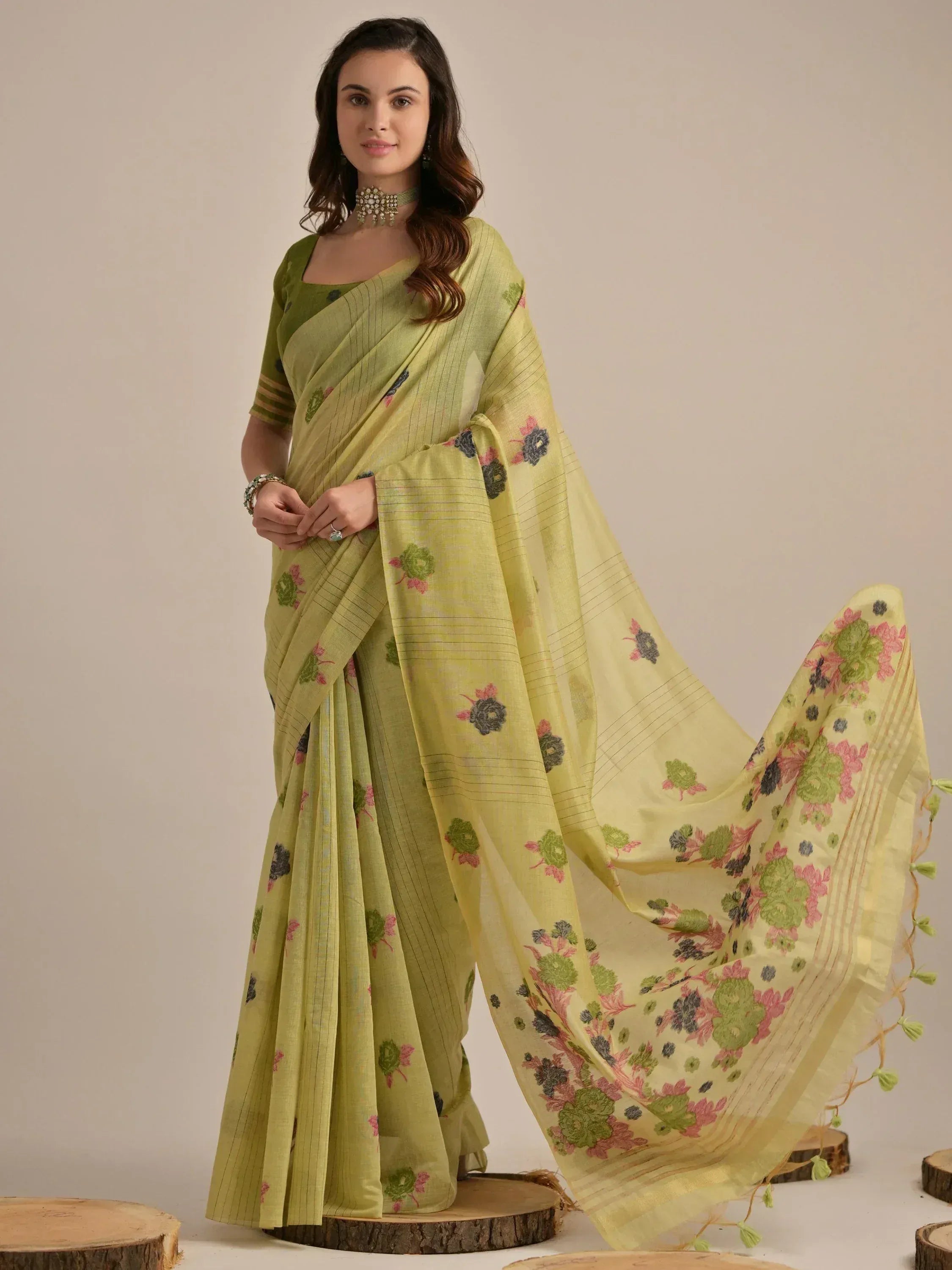 Elegant light green saree with floral embroidery and striped detailing, perfect for ethnic occasions.