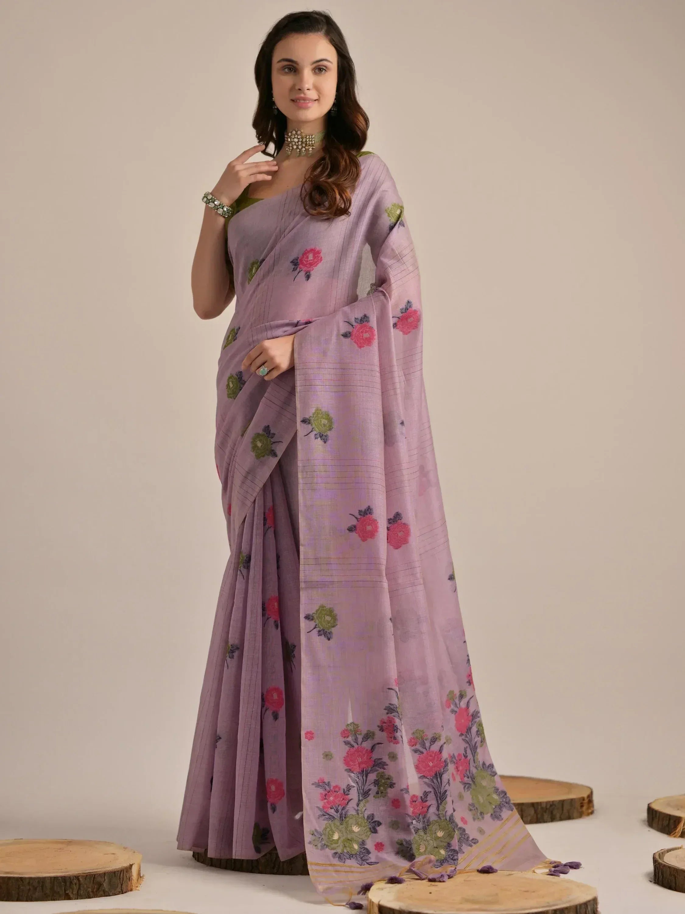 Purple floral saree with green and pink embroidery, paired with matching blouse for ethnic wear