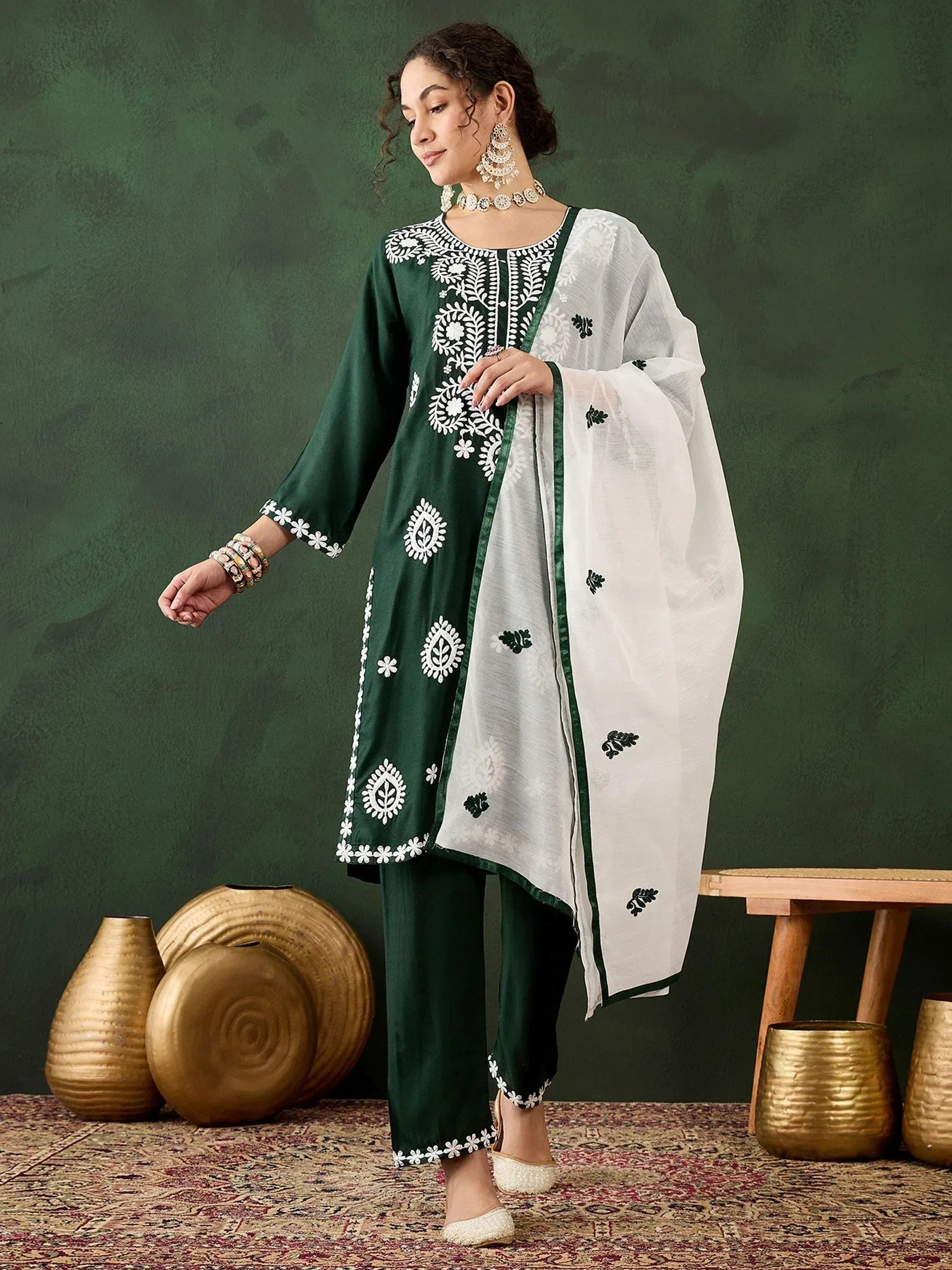 Green and white embroidered salwar kameez with floral motifs, perfect for Indian ethnic wear