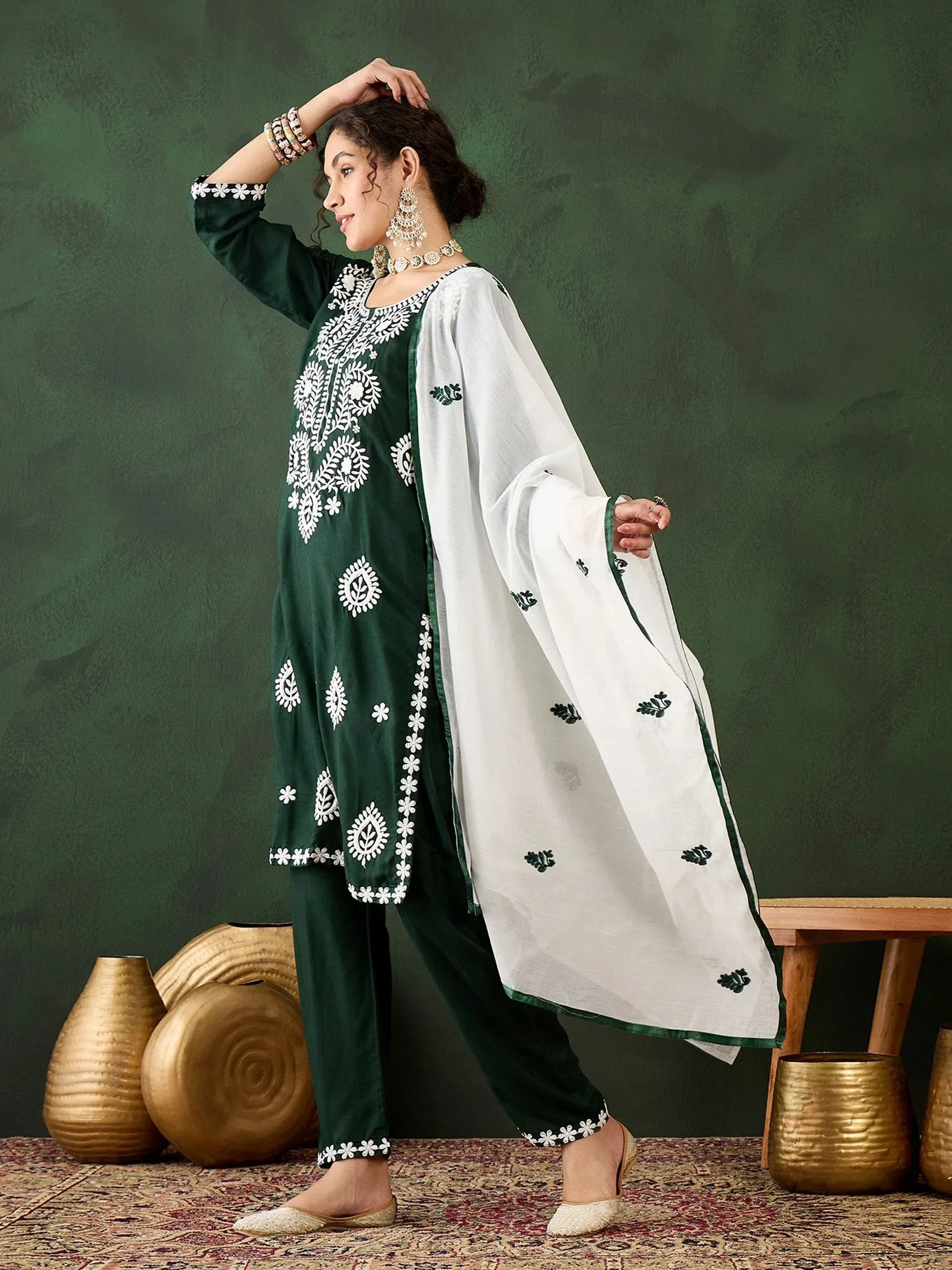 Green and white embroidered salwar kameez with floral detailing, perfect for ethnic wear occasions.