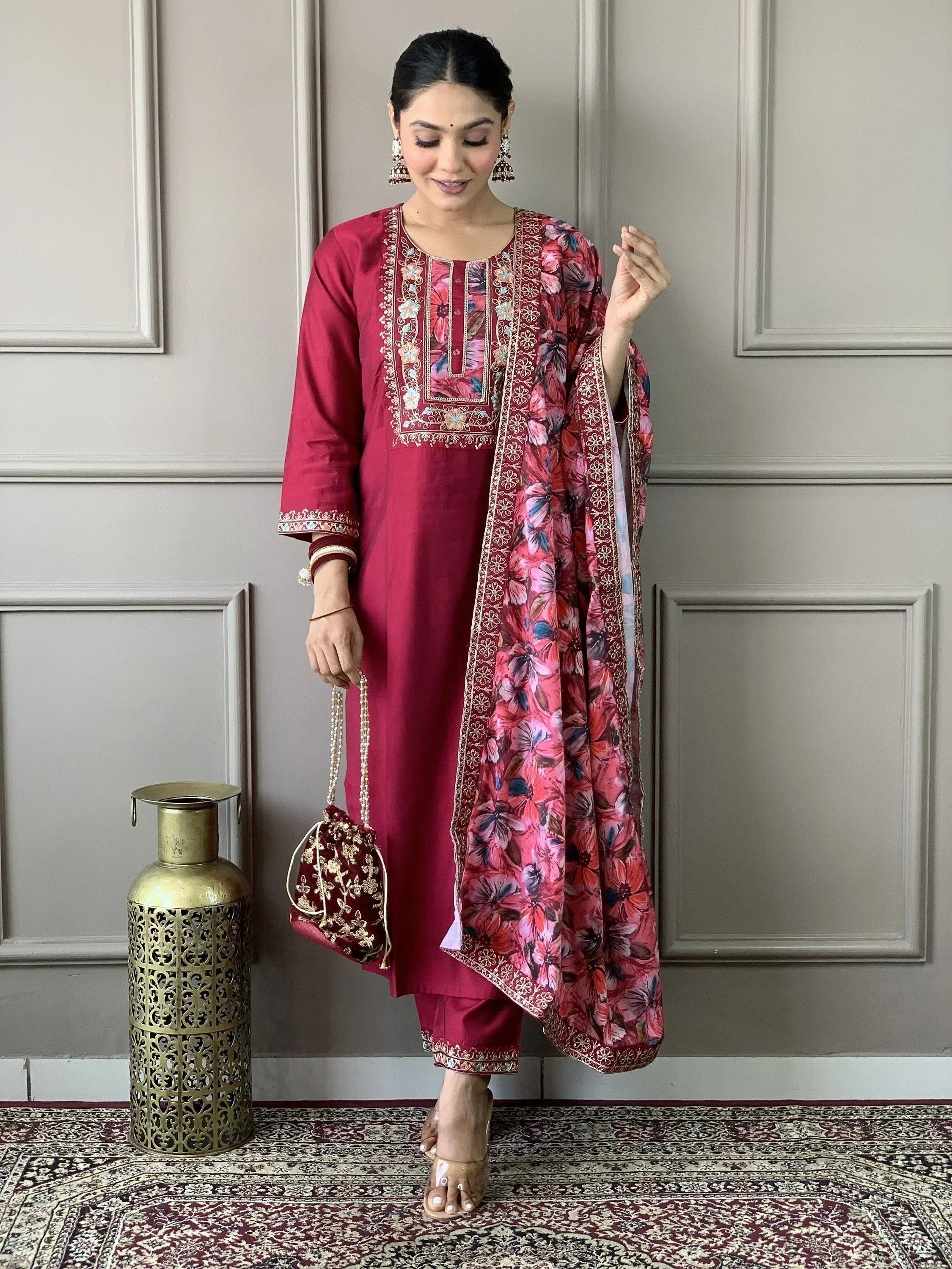 Maroon embroidered kurta with floral dupatta, paired with matching pants and potli bag for Indian ethnic wear