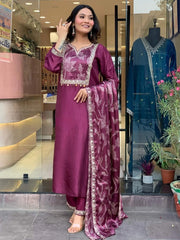 Woman in maroon embroidered salwar kameez with dupatta at Ethnic Plus Indian wear store entrance