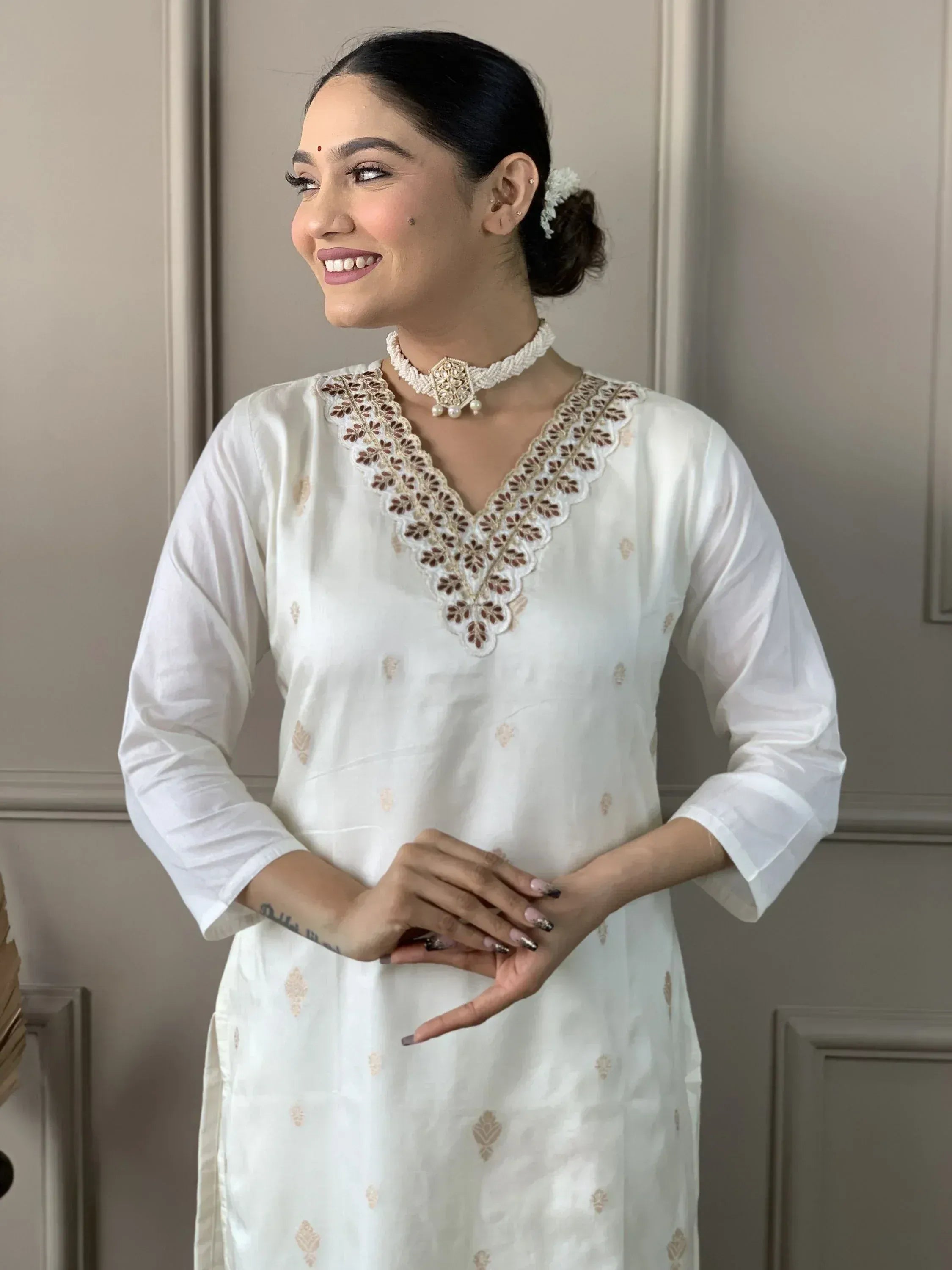 White ethnic kurti with embroidered V-neck, perfect for Indian wear and festive occasions