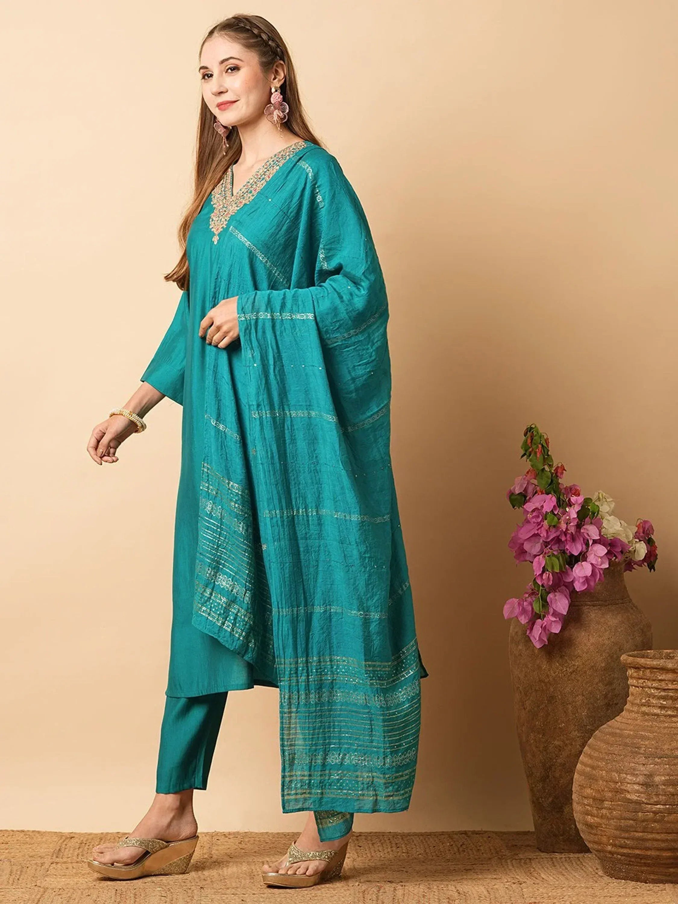 Teal ethnic kurti with embroidered details and matching pants, styled with wedge sandals