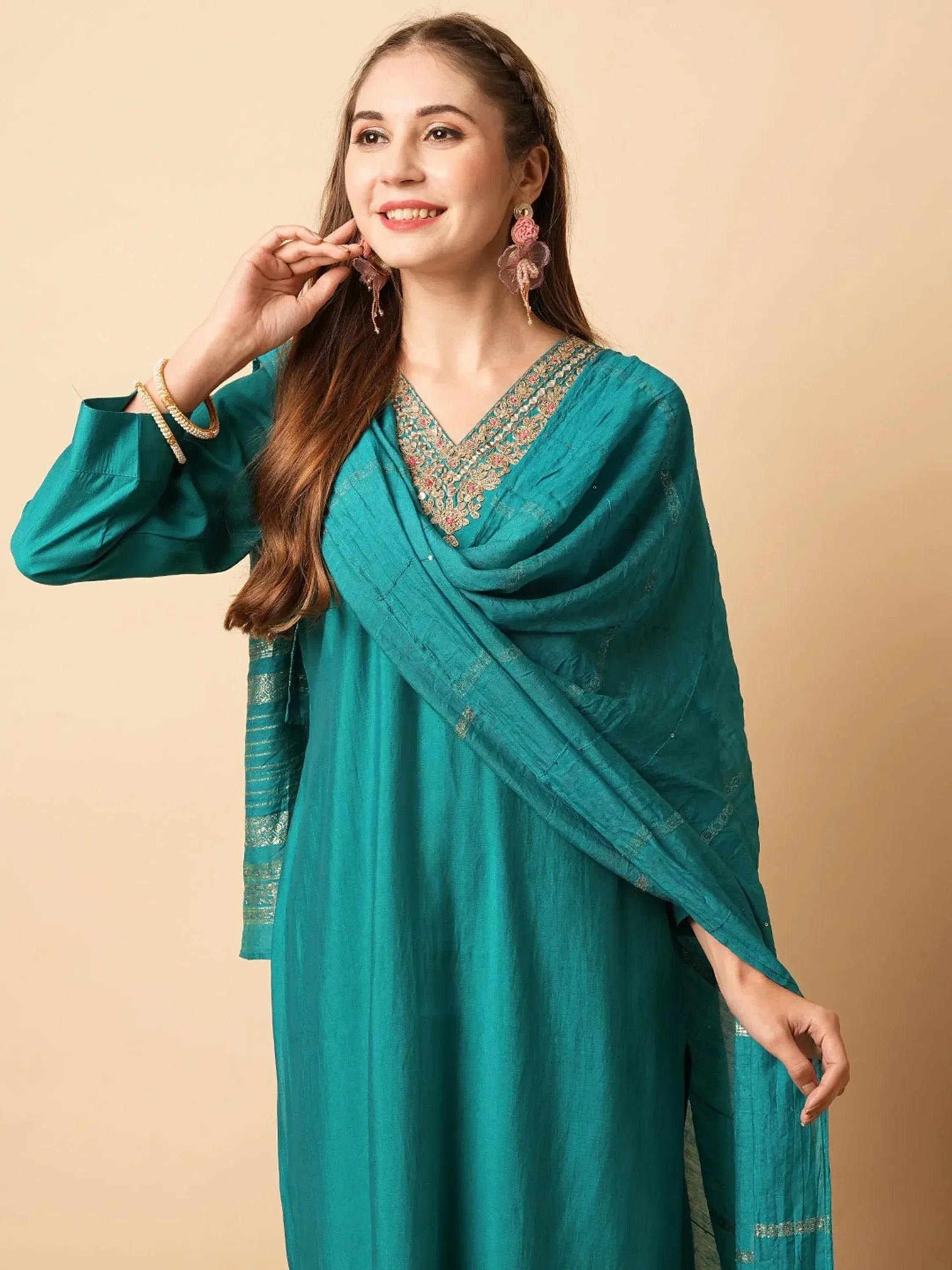 Teal ethnic kurti with embroidered neckline and matching dupatta, styled with floral earrings for festive occasions.
