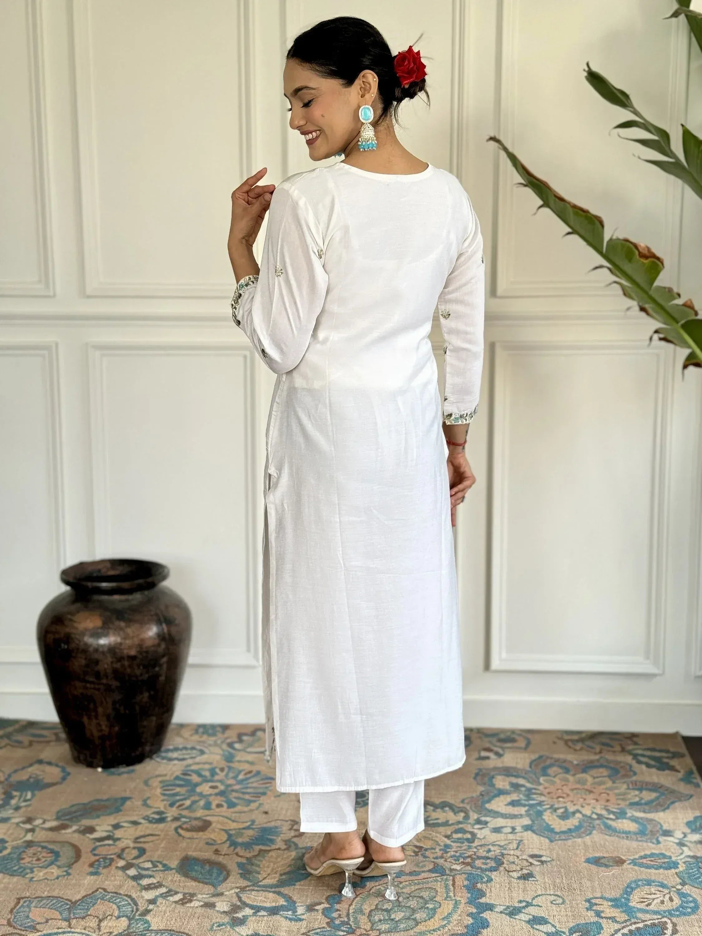 White ethnic kurta with embroidered sleeves and side slits, paired with palazzo pants for Indian wear