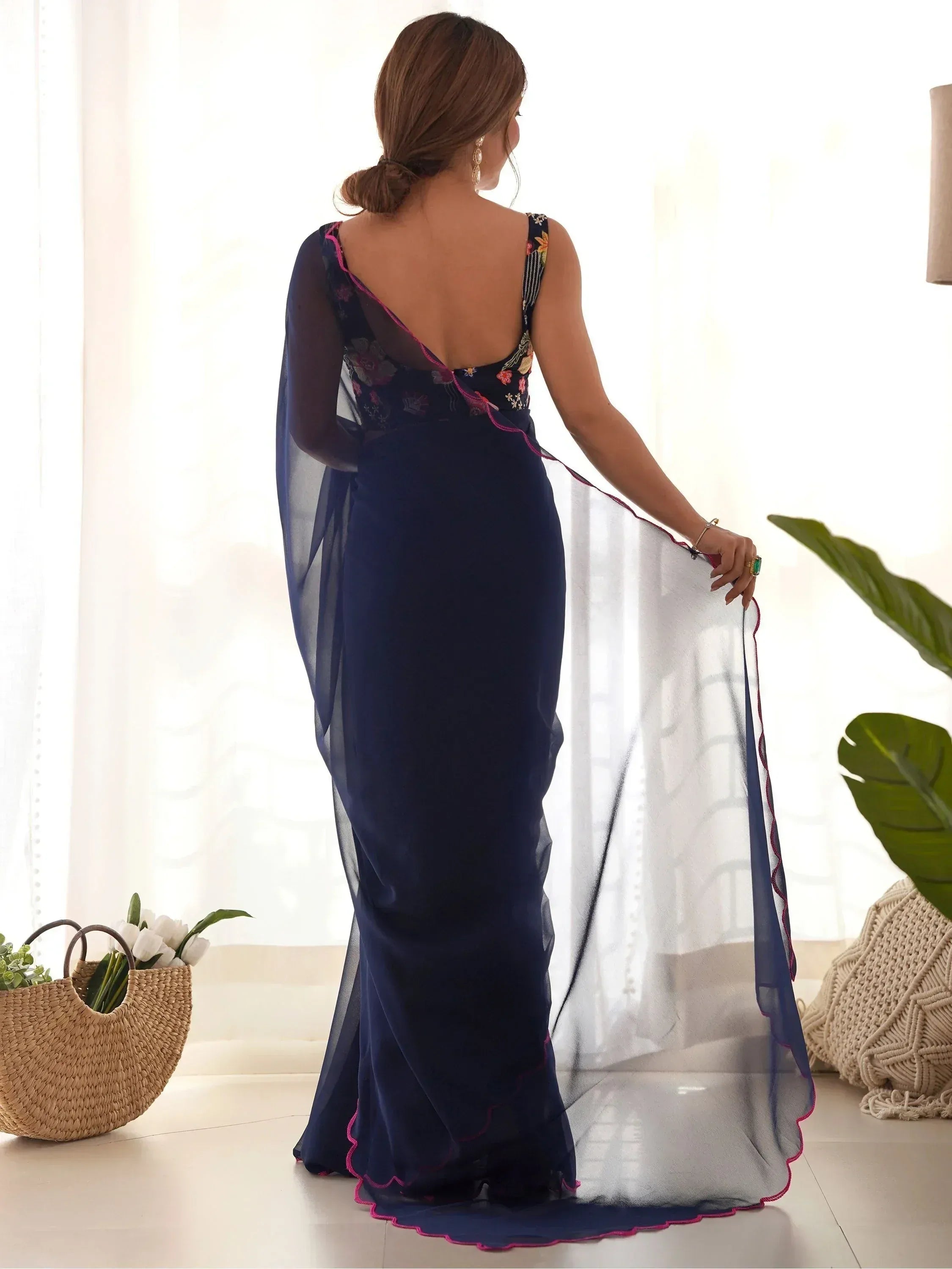 Navy blue embroidered ethnic gown with sheer overlay and pink trim, back view