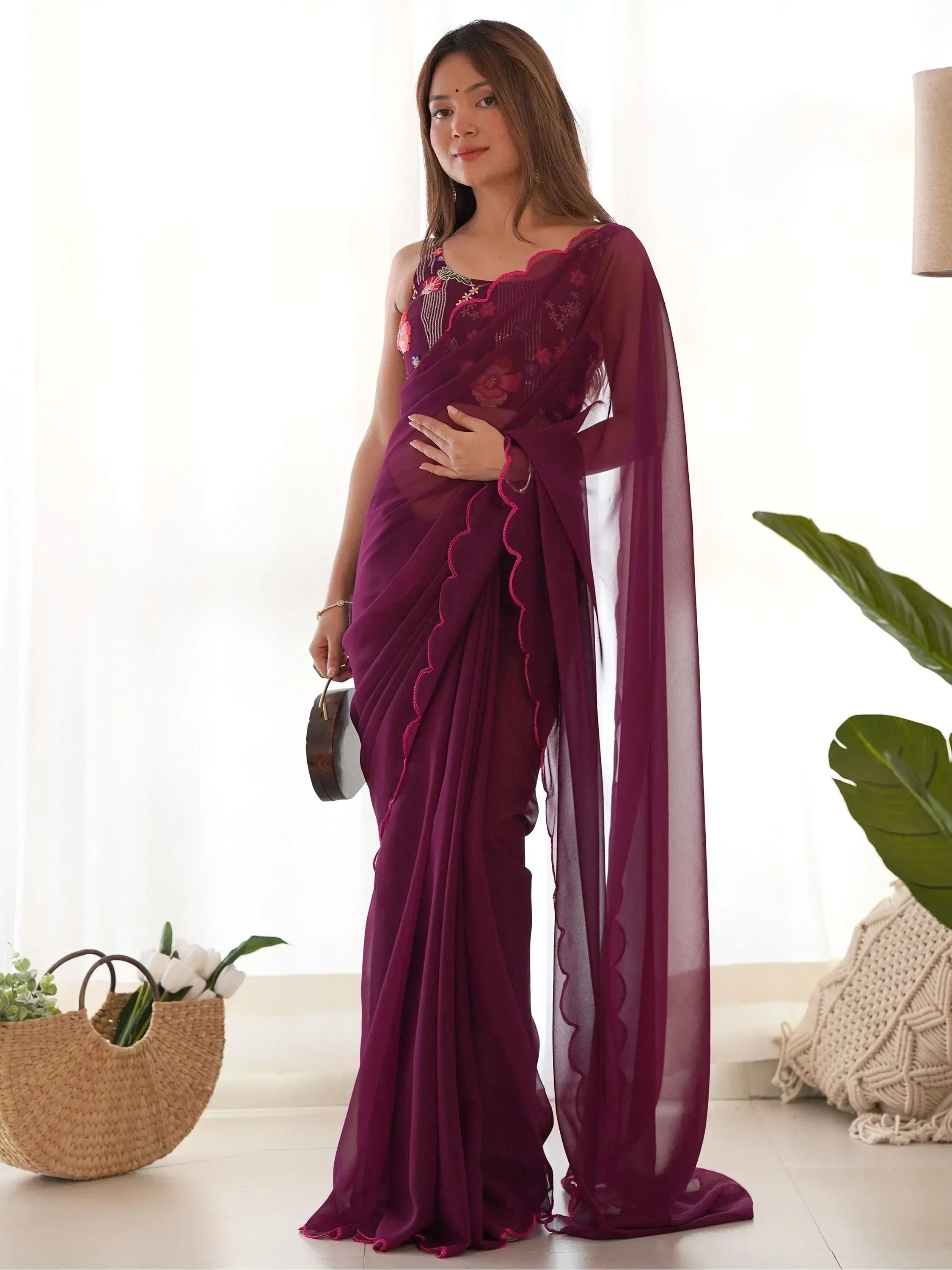 Elegant purple saree with floral embroidery and scalloped edges, perfect for Indian ethnic wear occasions.