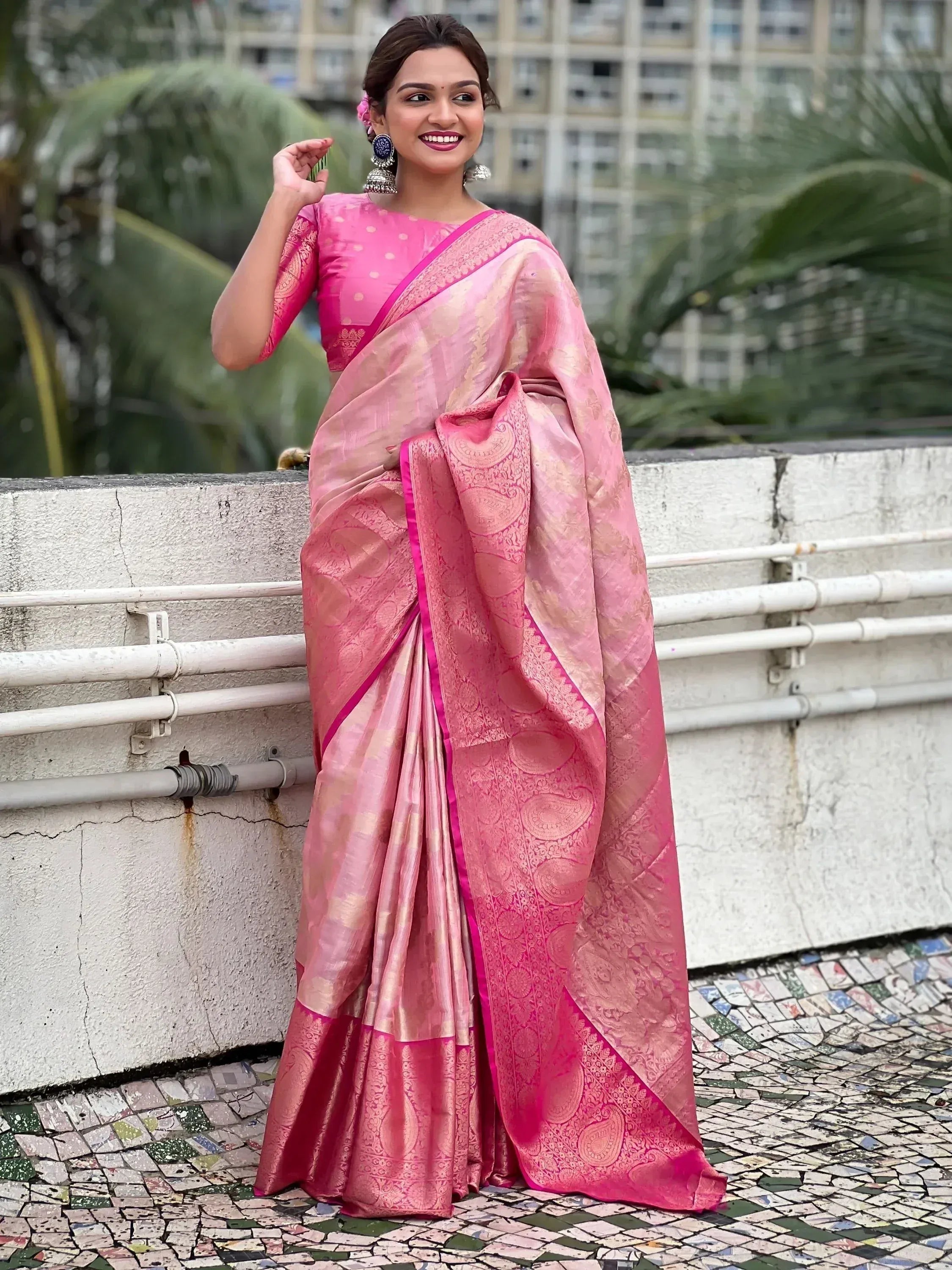 Pink designer saree with gold paisley motifs, perfect for Indian ethnic wear and festive occasions.