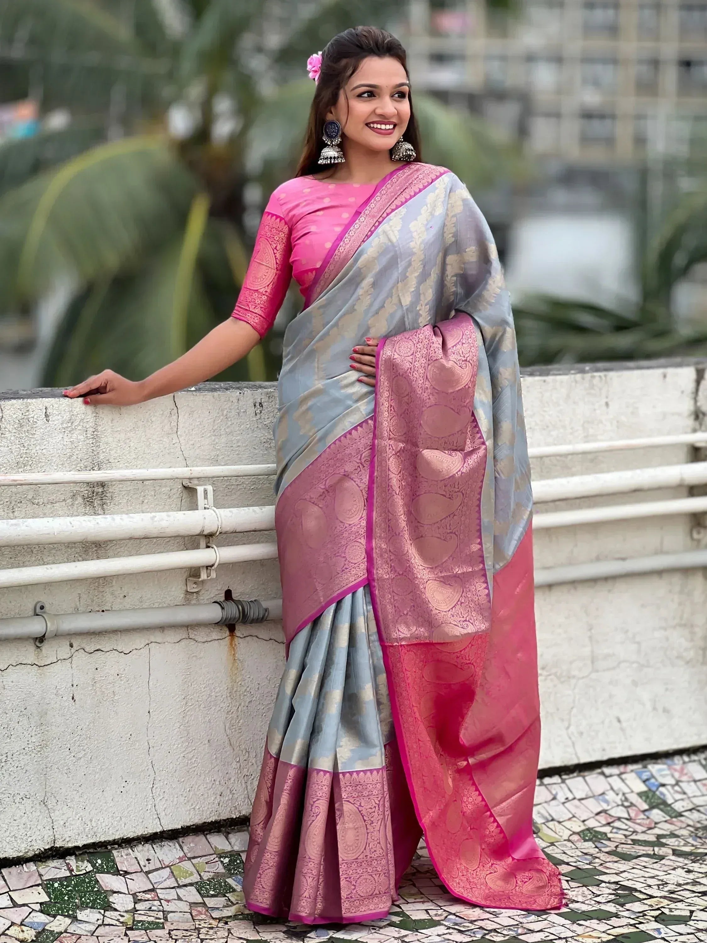 Woman in elegant grey and pink designer saree with gold motifs, perfect for Indian ethnic occasions
