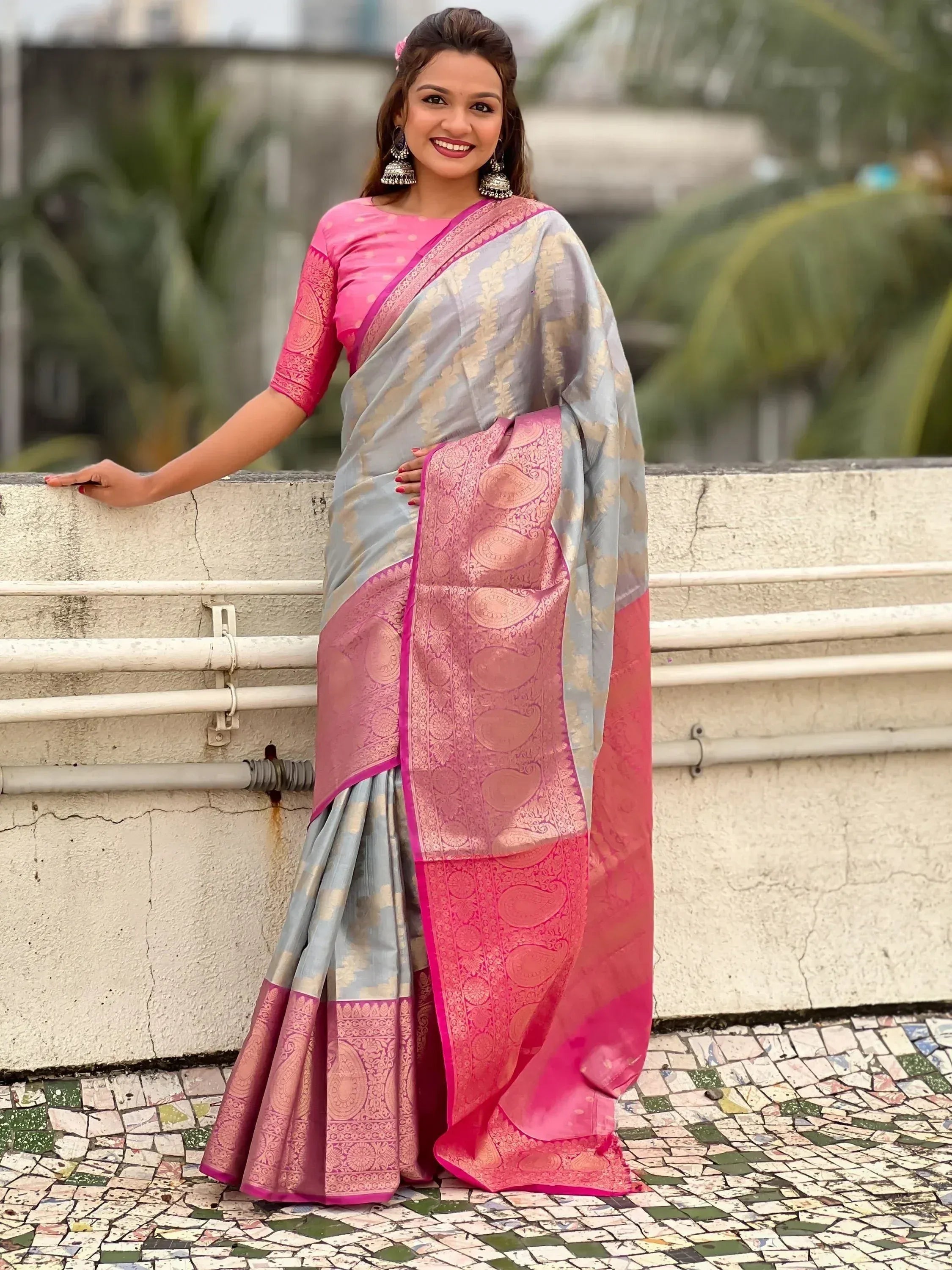 Woman in elegant grey and pink designer saree with gold paisley print, perfect for Indian ethnic occasions