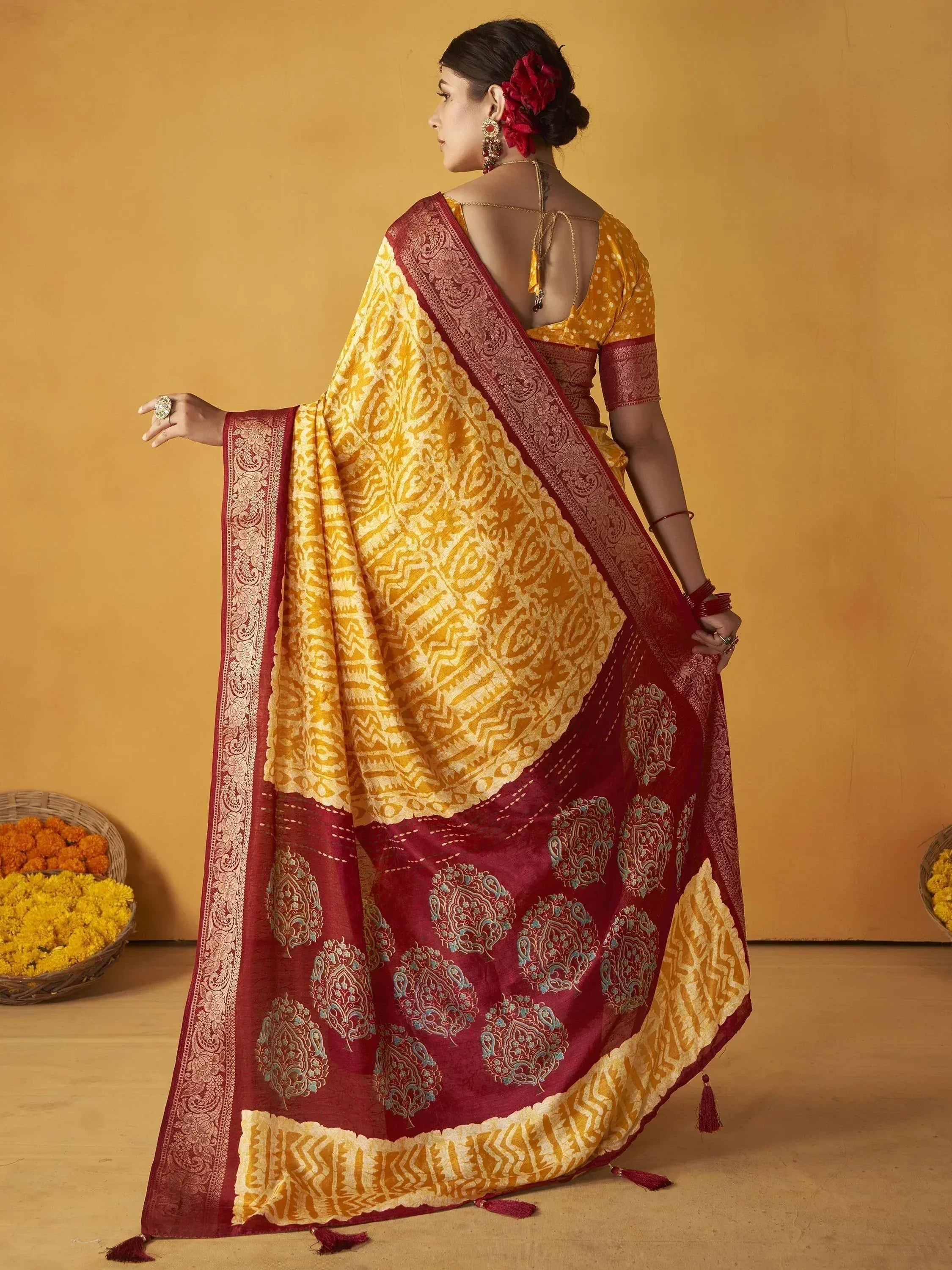 Yellow and maroon designer saree with intricate paisley print, perfect for ethnic occasions