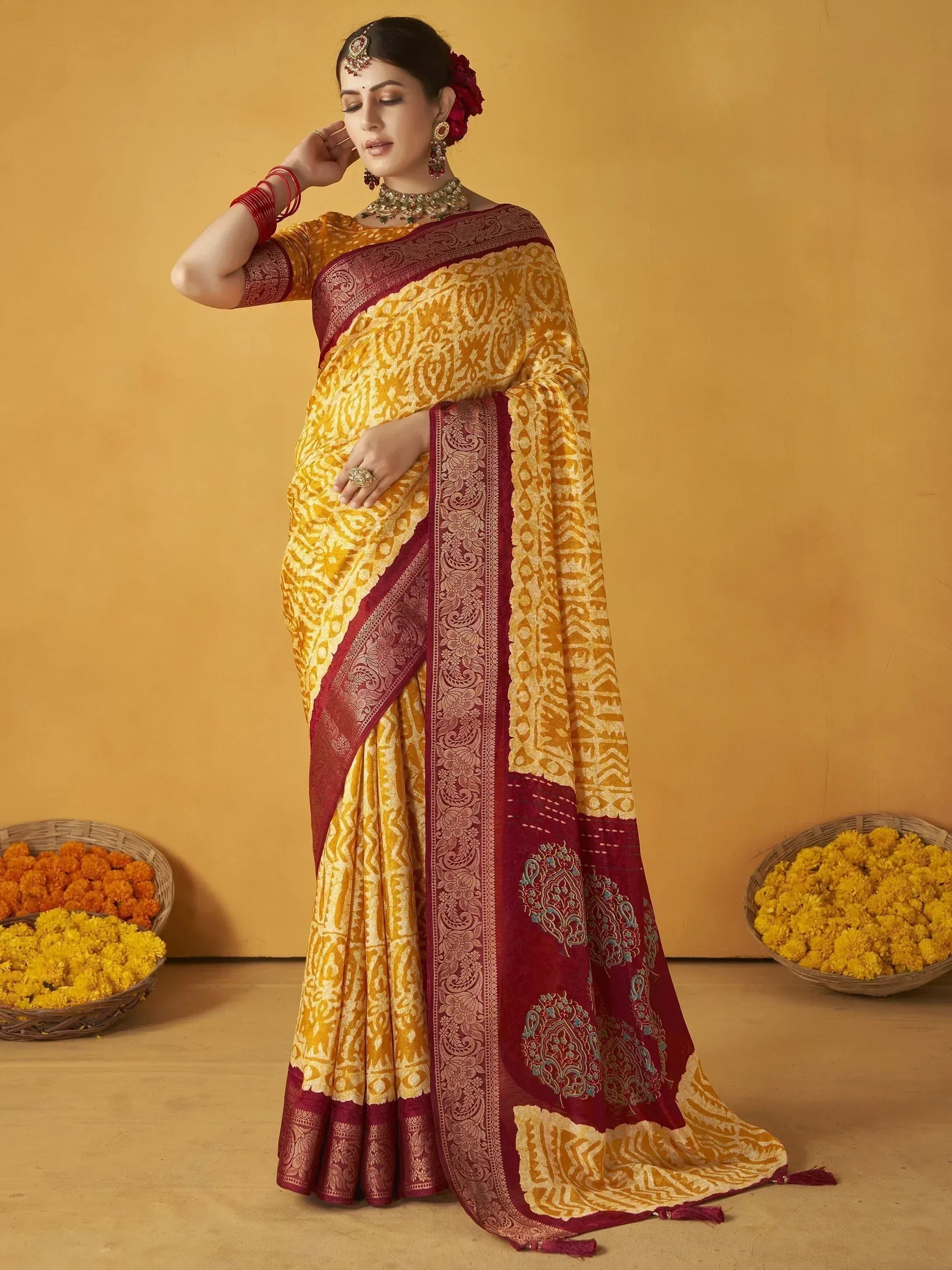 Yellow and maroon designer saree with intricate patterns, perfect for Indian ethnic wear occasions