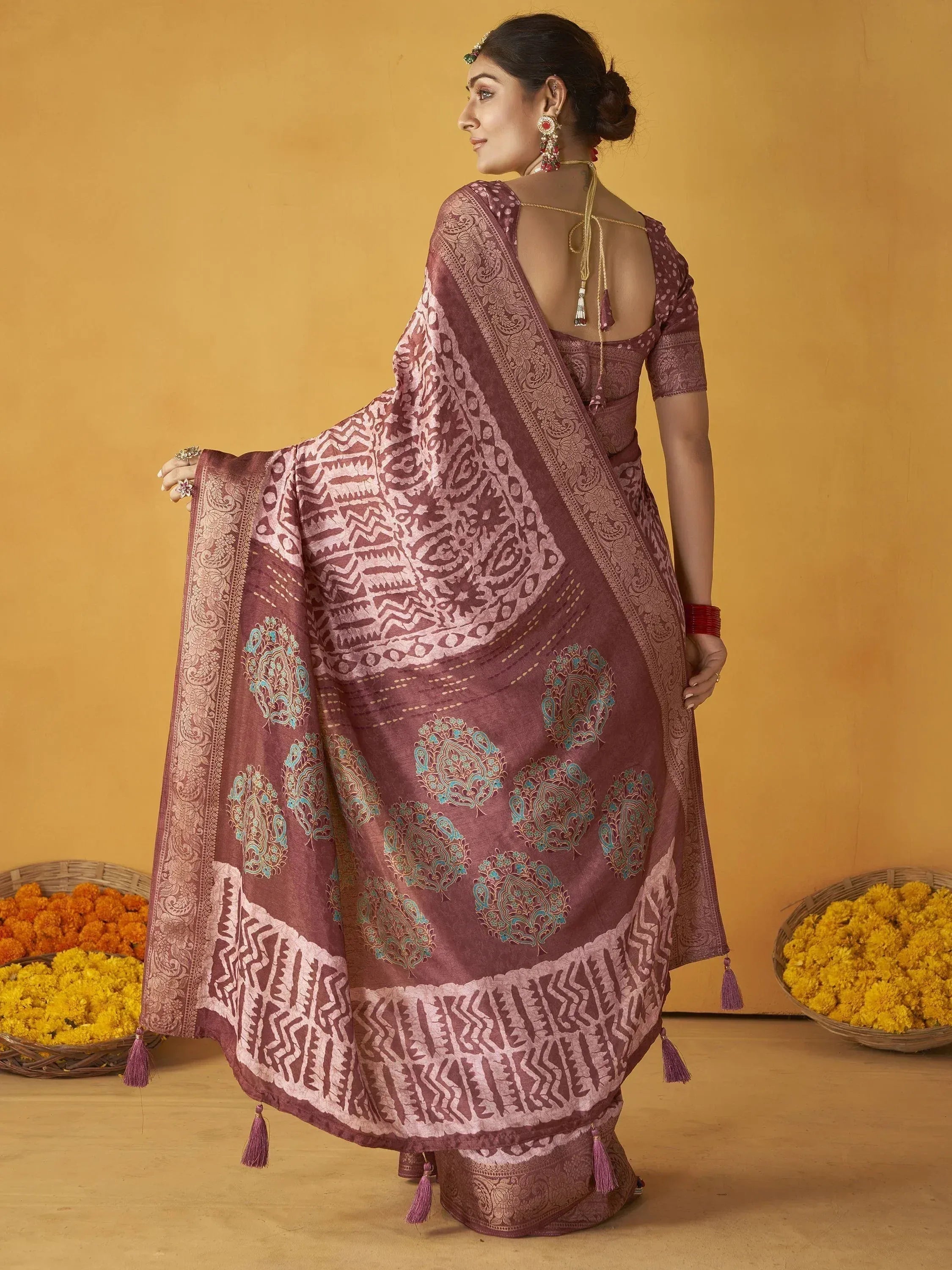 Elegant maroon saree with intricate paisley and geometric prints, tassels, and backless blouse for Indian ethnic wear