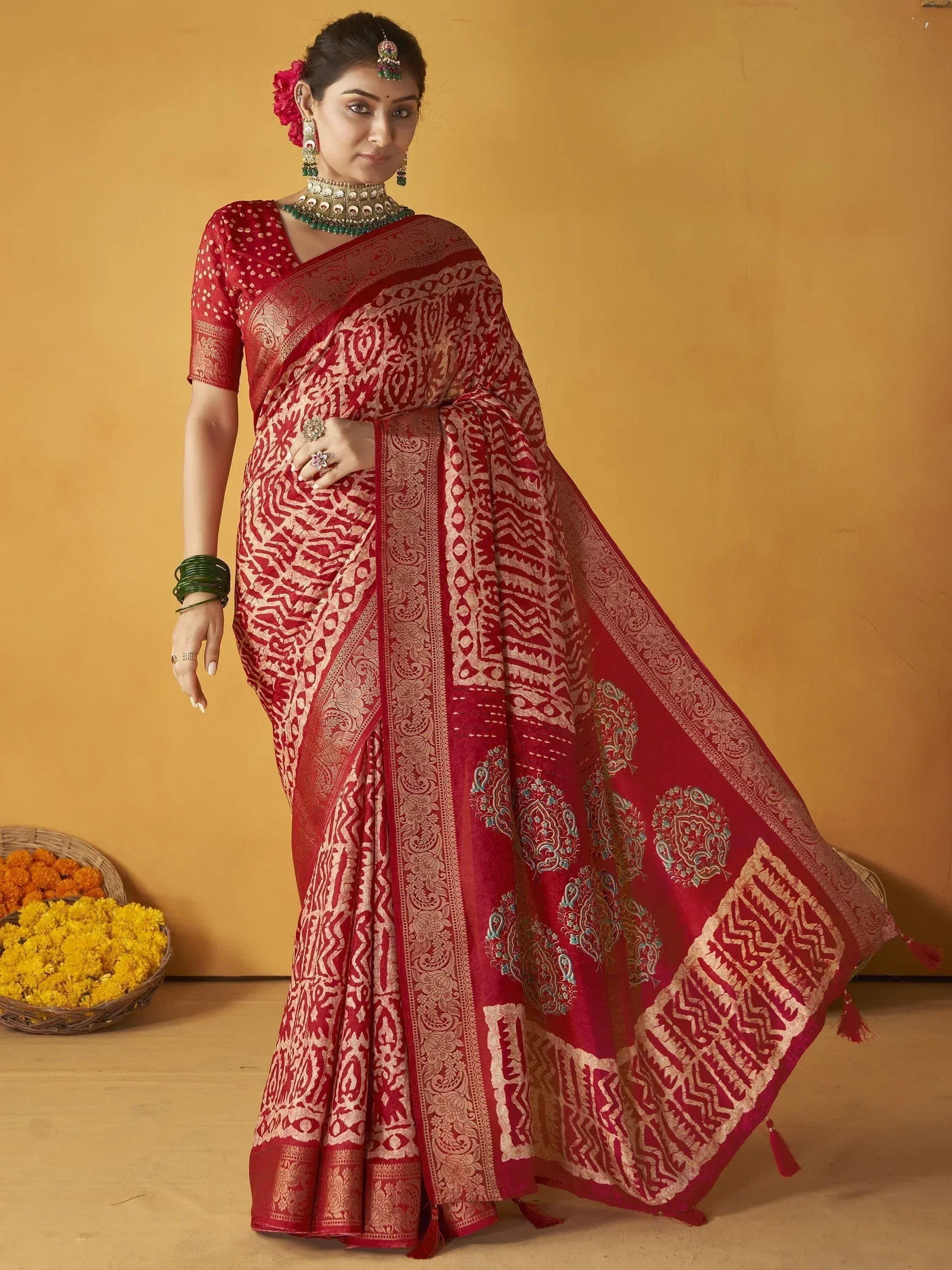 Red and gold designer saree with intricate paisley and geometric patterns, perfect for Indian ethnic wear occasions.