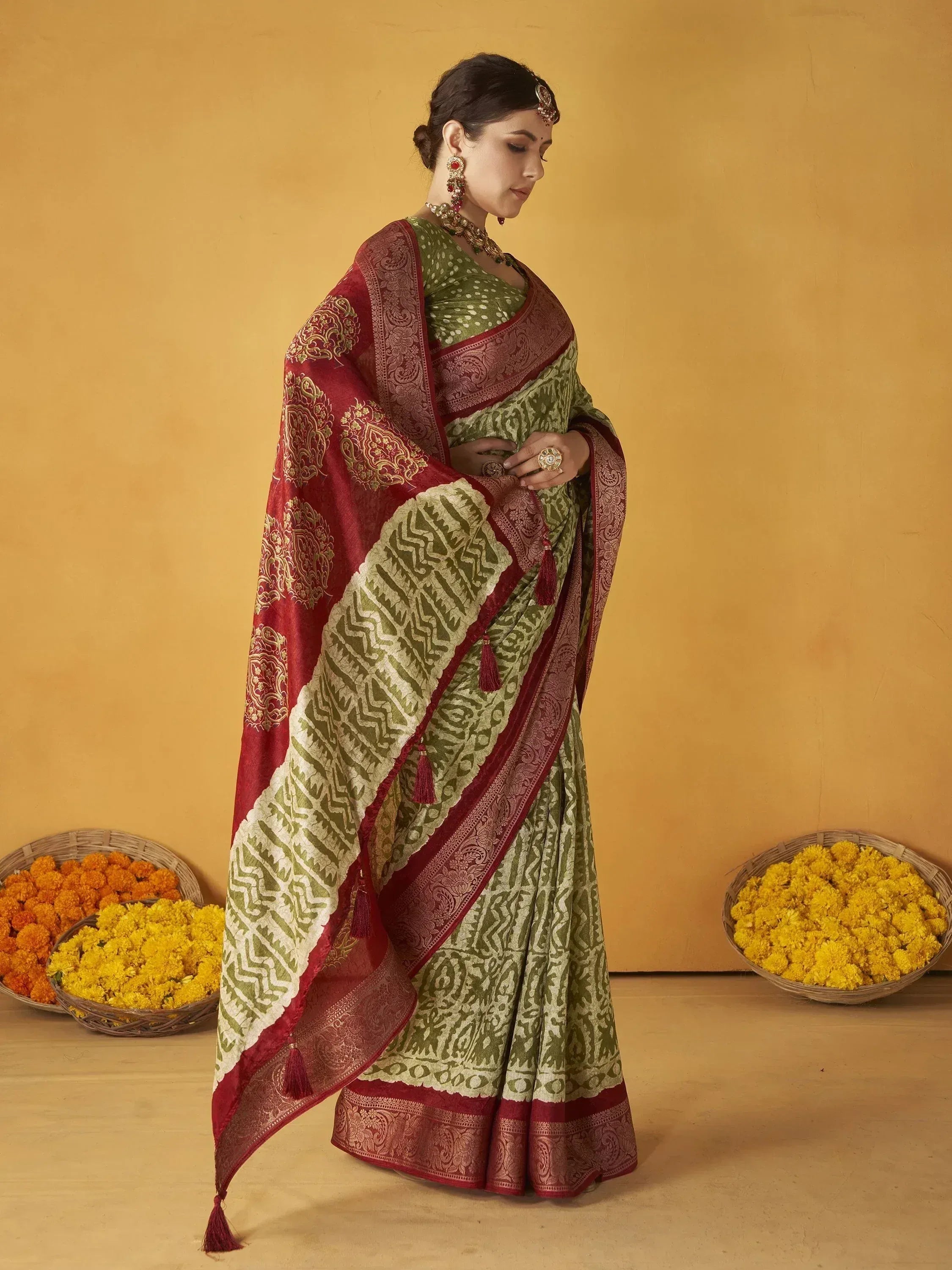 Green and maroon ethnic saree with intricate patterns, perfect for Indian weddings and festivals