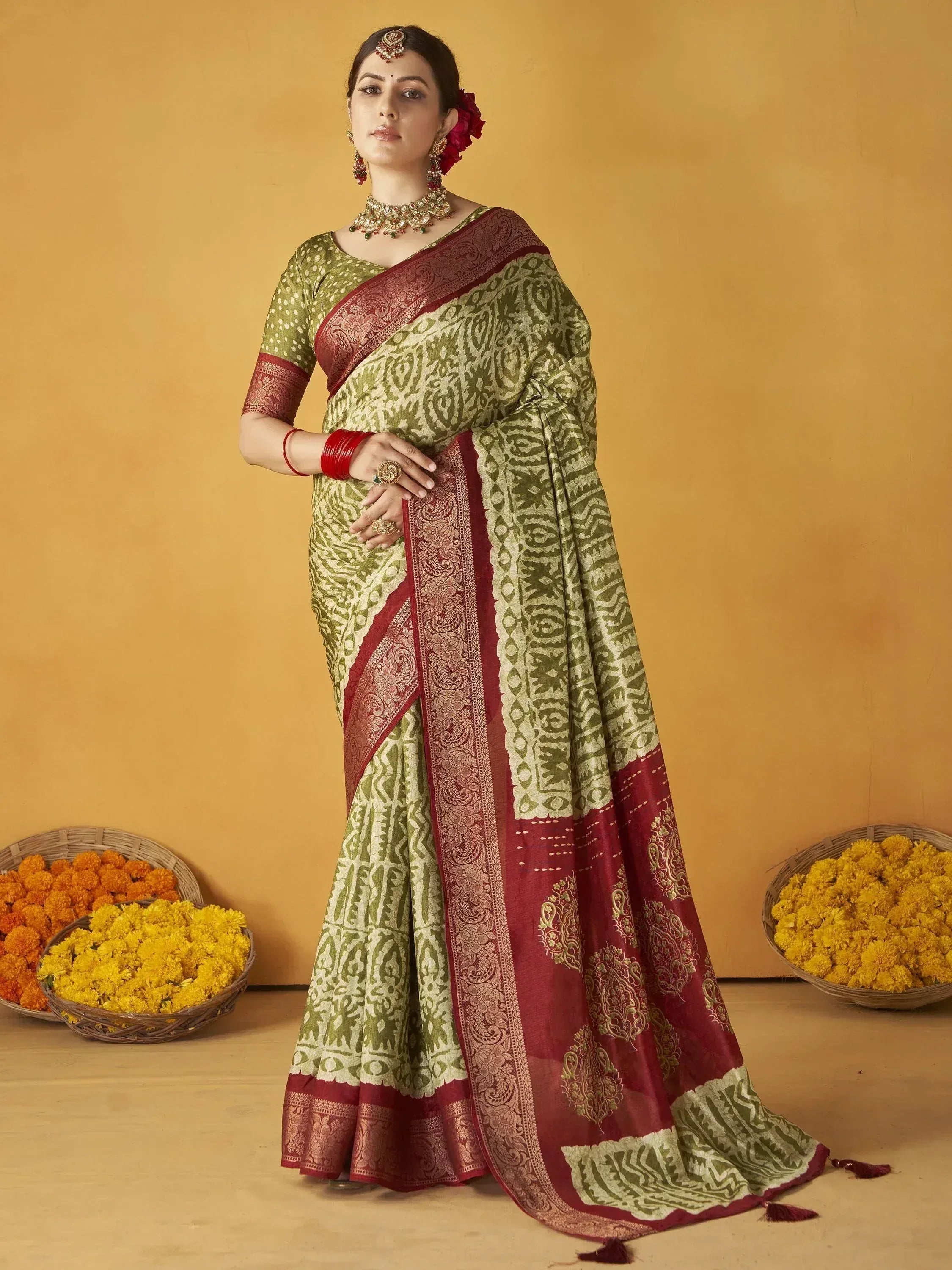 Woman in olive green and maroon printed saree with gold border, traditional Indian ethnic wear