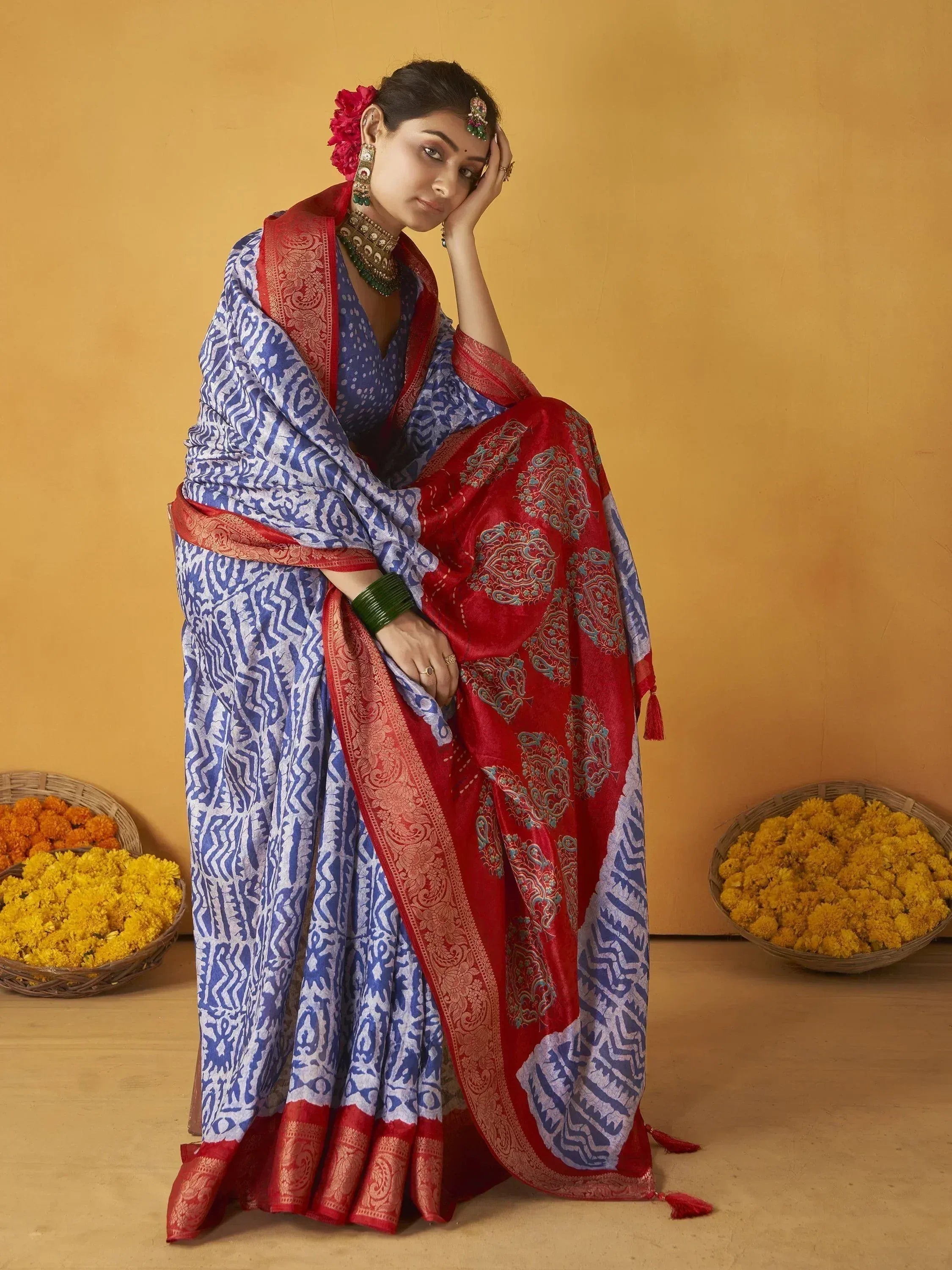Blue and red printed saree with gold border, traditional Indian ethnic wear, floral accessories, marigold baskets