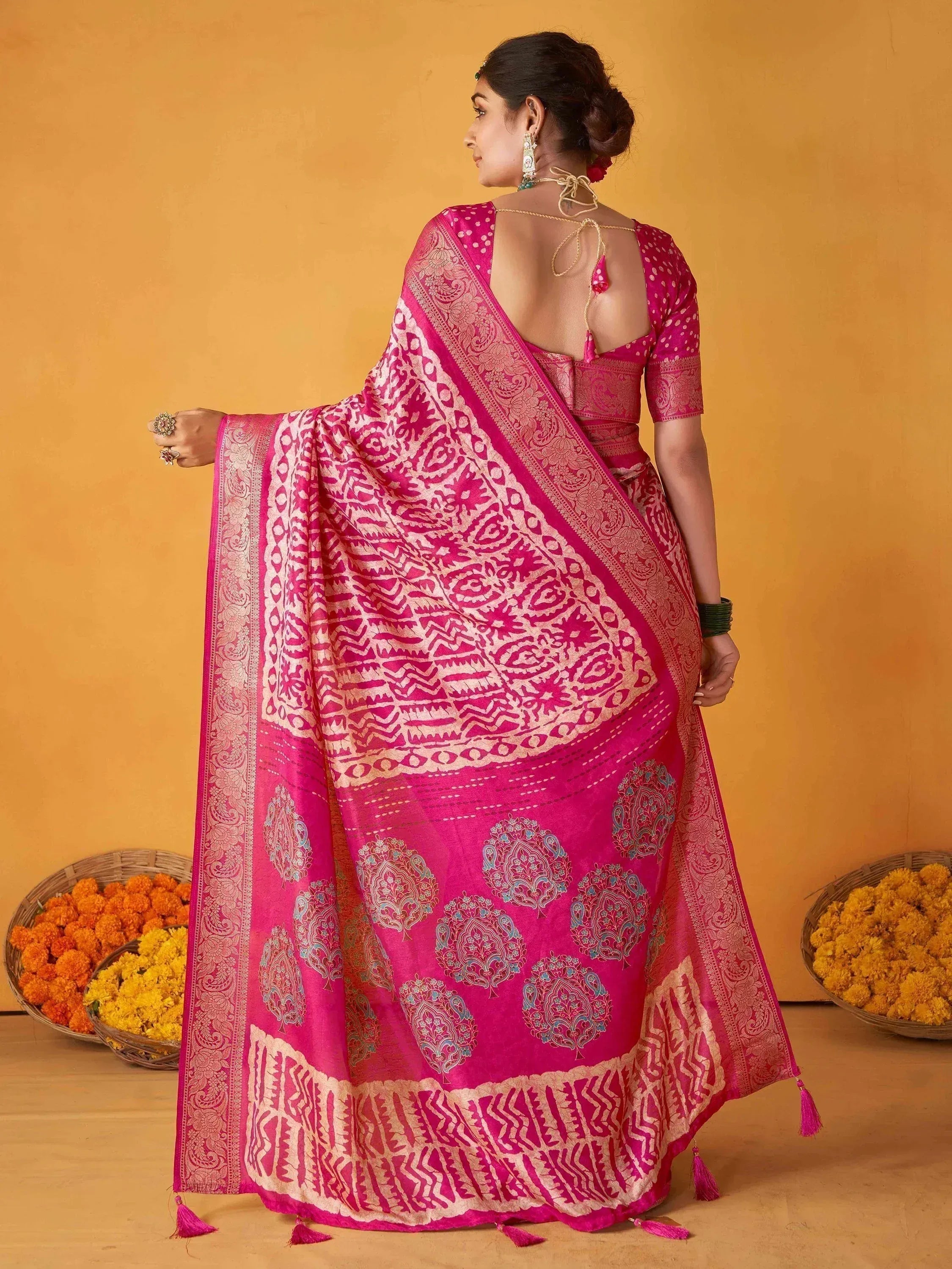Pink designer saree with intricate patterns and tassels, perfect for ethnic occasions