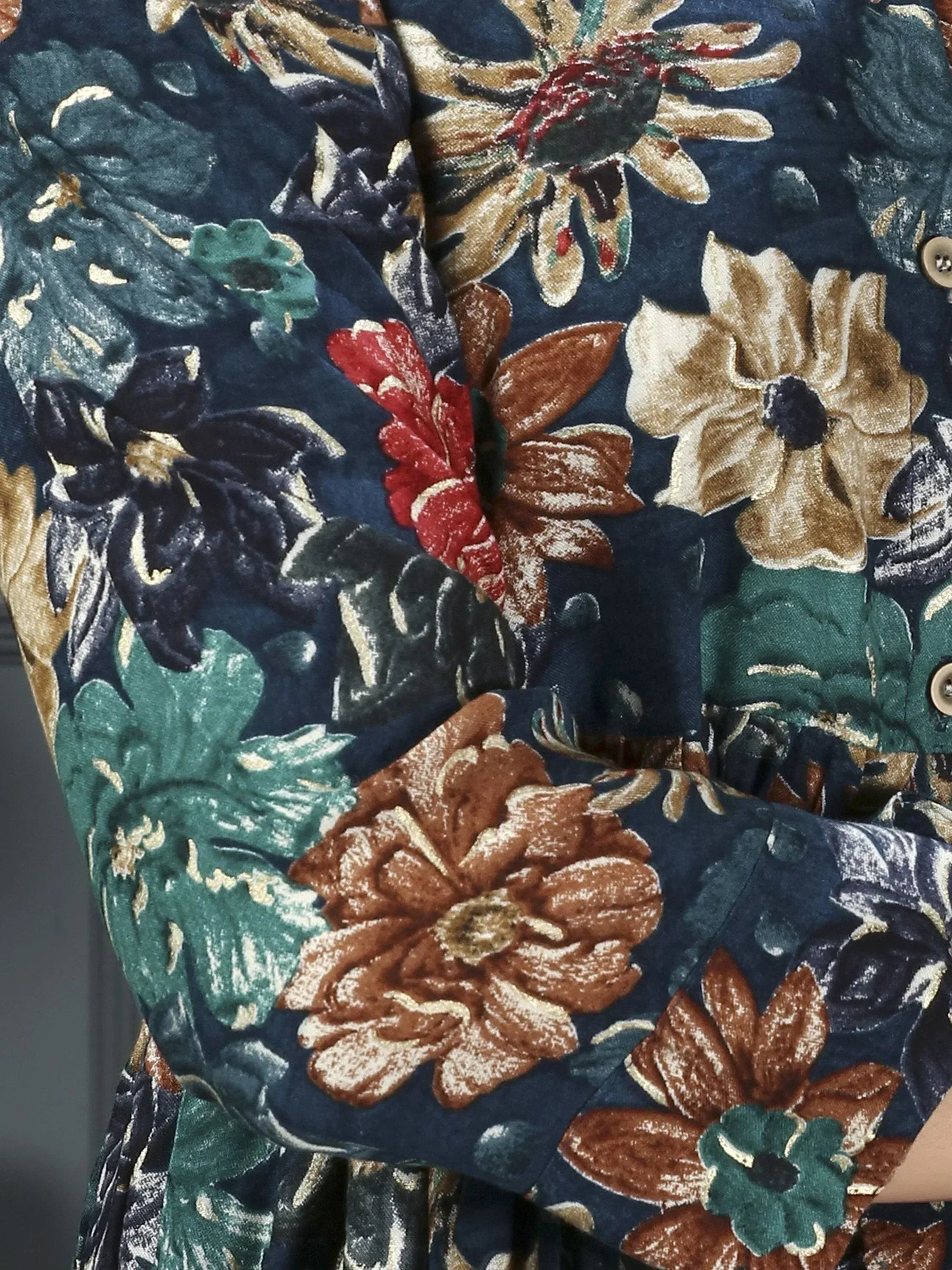 Navy blue floral print ethnic gown with vibrant red, gold, and green flowers, perfect for Indian occasions.