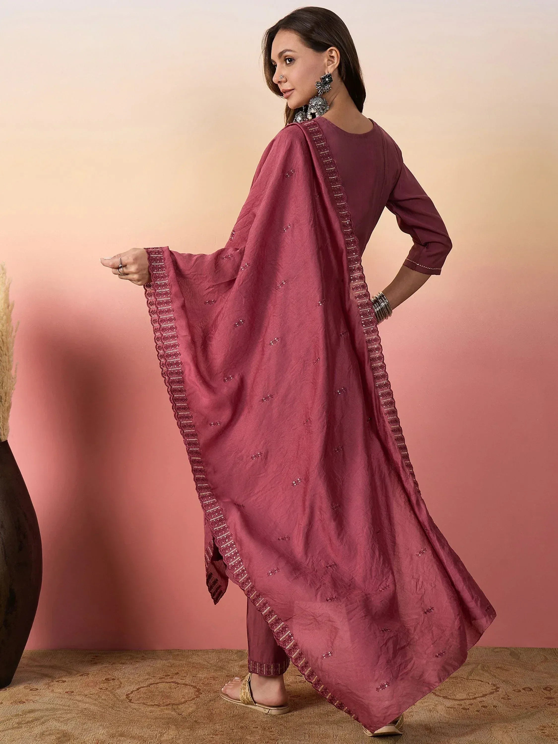 Woman in maroon ethnic salwar kameez with embroidered dupatta, perfect for Indian occasions