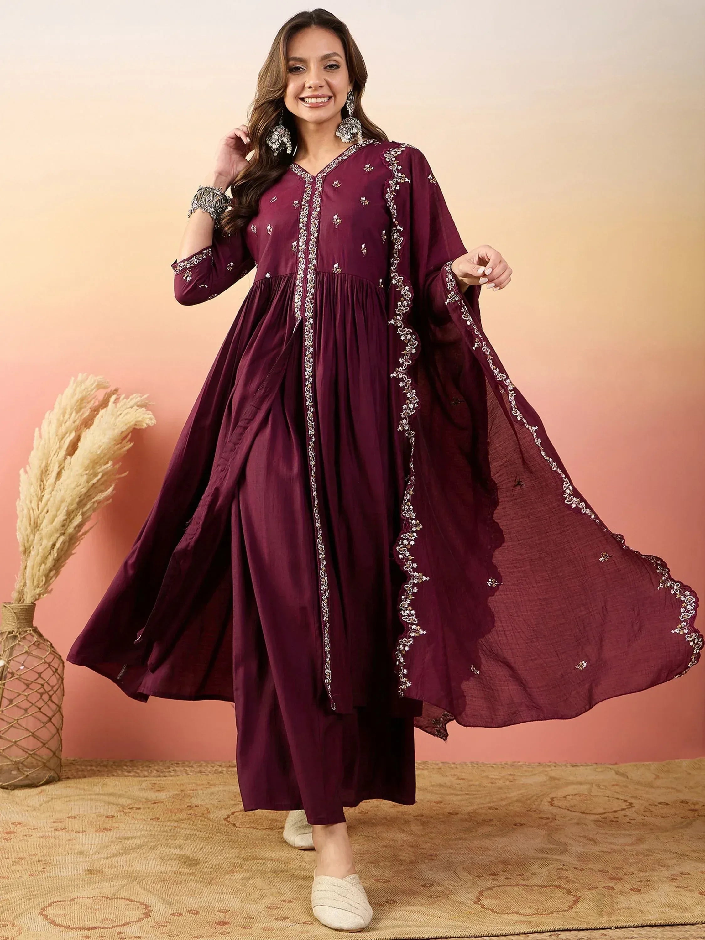 Elegant maroon ethnic gown with floral embroidery, perfect for Indian occasions and festive wear.