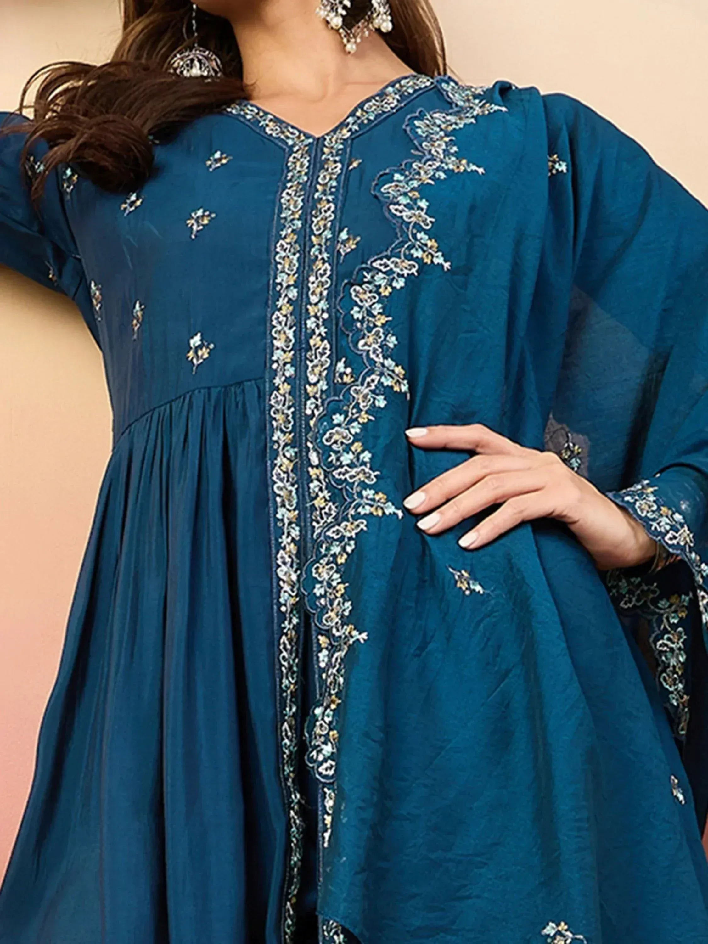 Teal blue ethnic gown with floral embroidery, perfect for Indian wear and festive occasions.