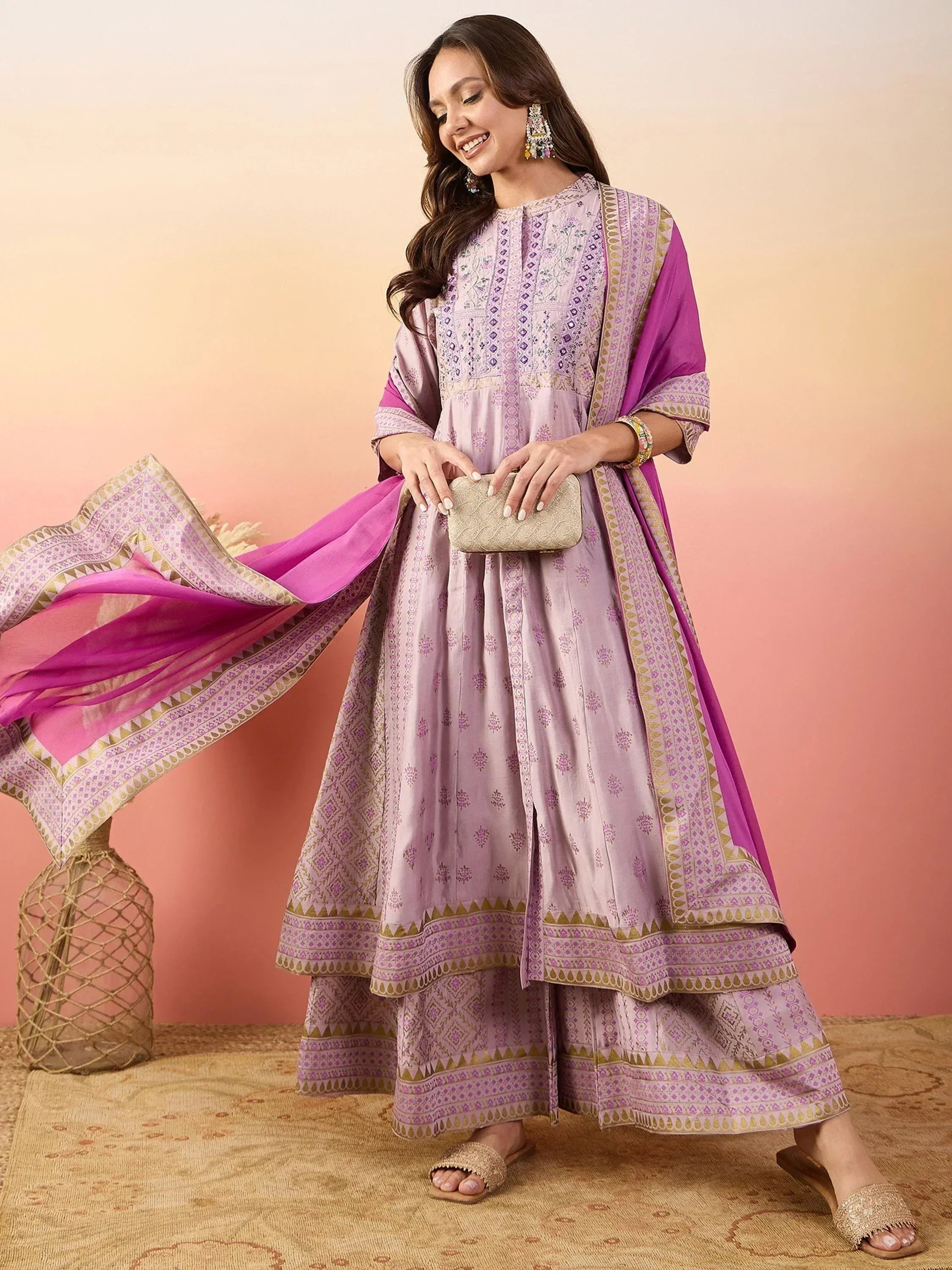 Woman in lavender embroidered anarkali suit with pink dupatta, ethnic Indian wear