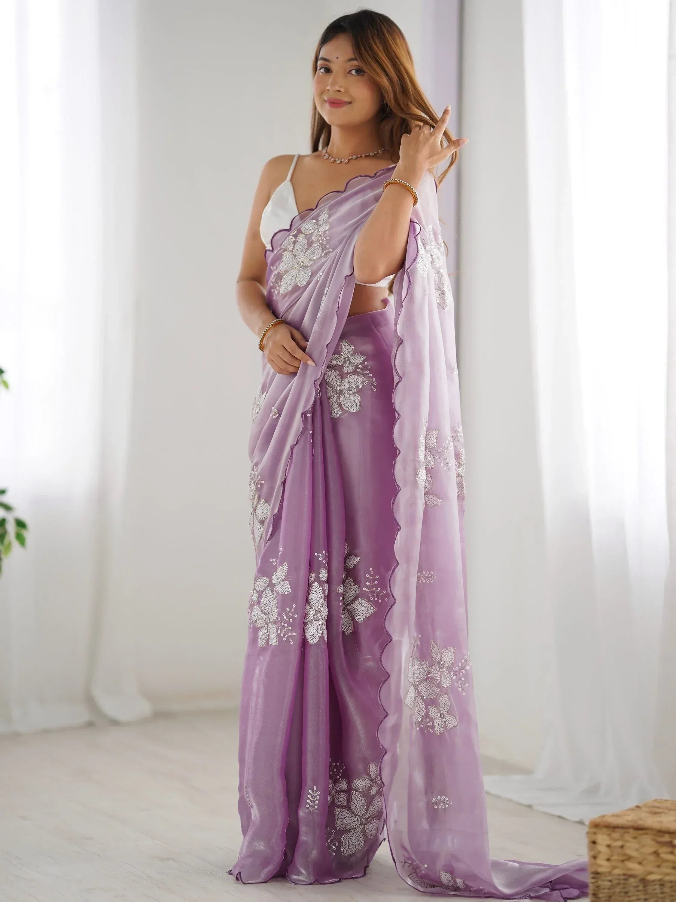 Lavender saree with white floral embroidery and scalloped border, paired with white blouse for ethnic wear