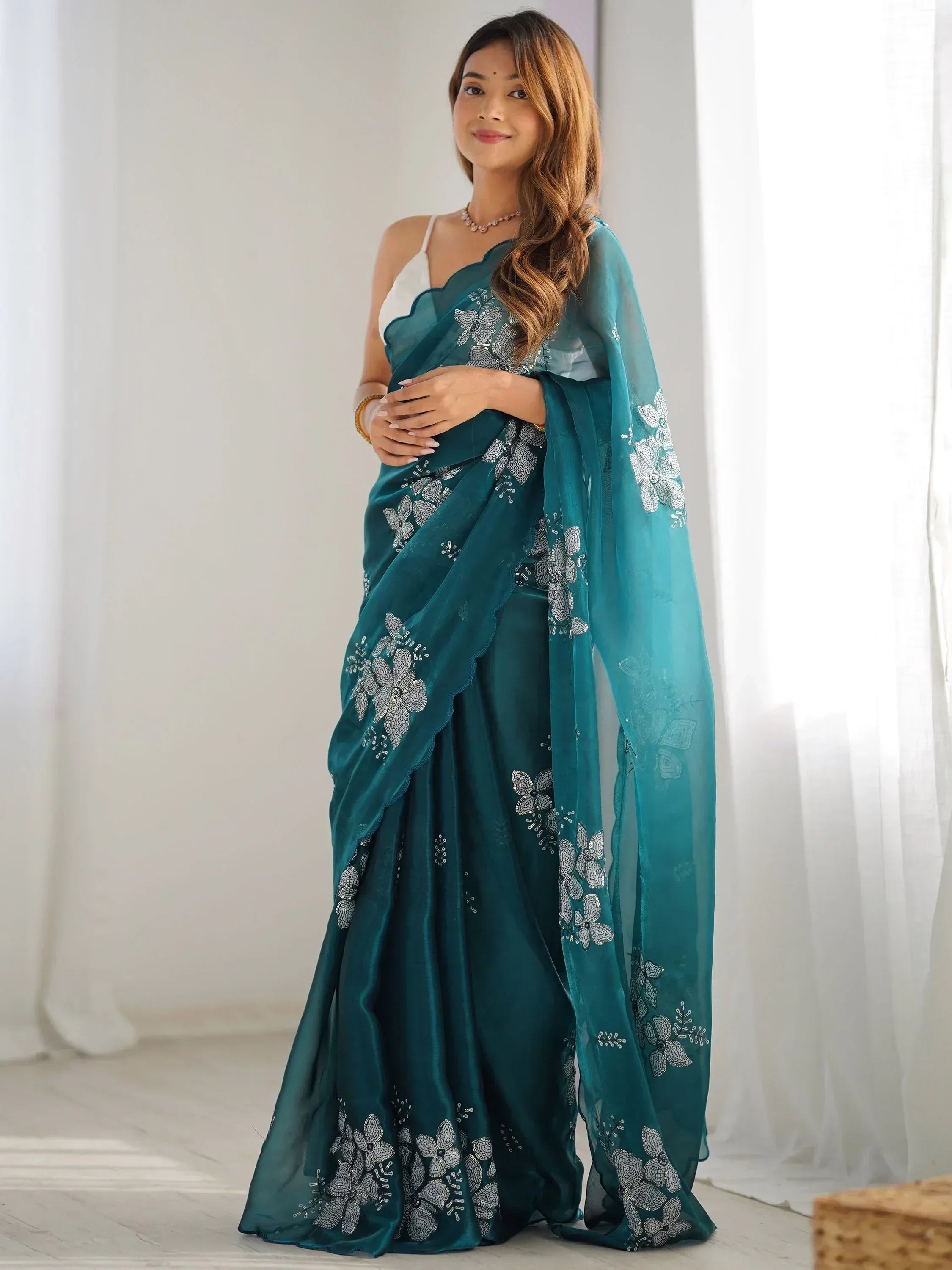 Teal embroidered saree with floral zari work, perfect for Indian ethnic occasions and festive wear.