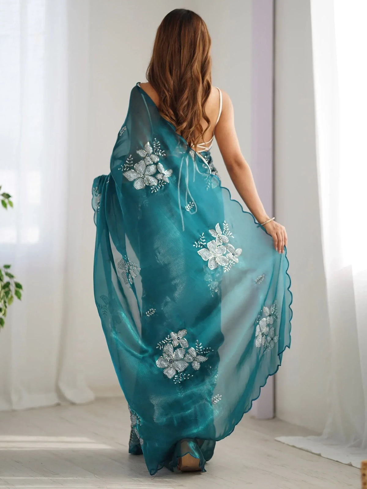Teal ethnic gown with silver floral embroidery, sheer overlay, and scalloped hem for women's festive wear