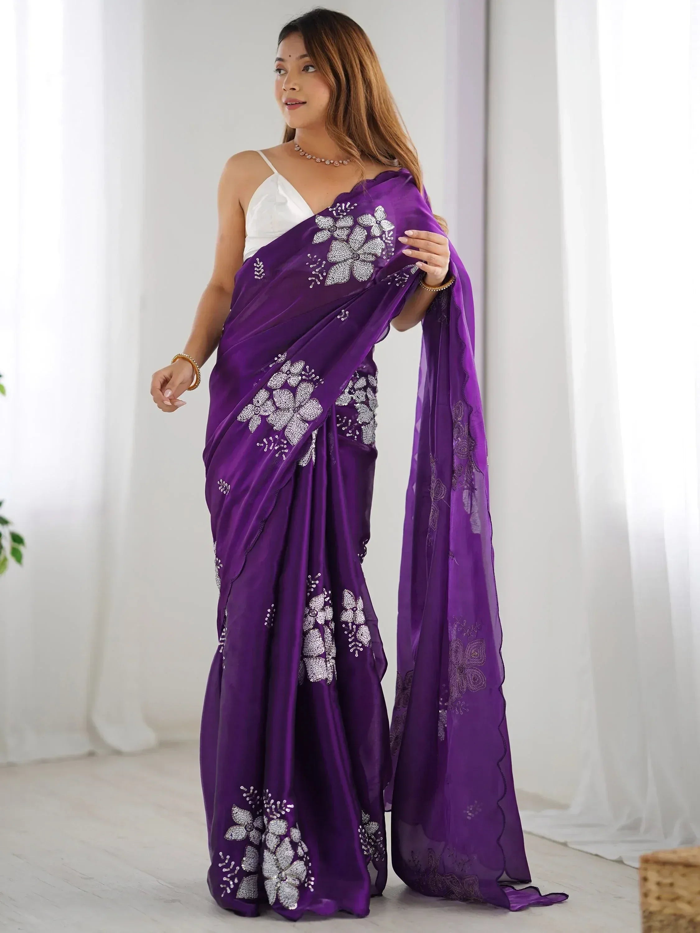Purple embroidered saree with floral embellishments, styled with white blouse for ethnic wear