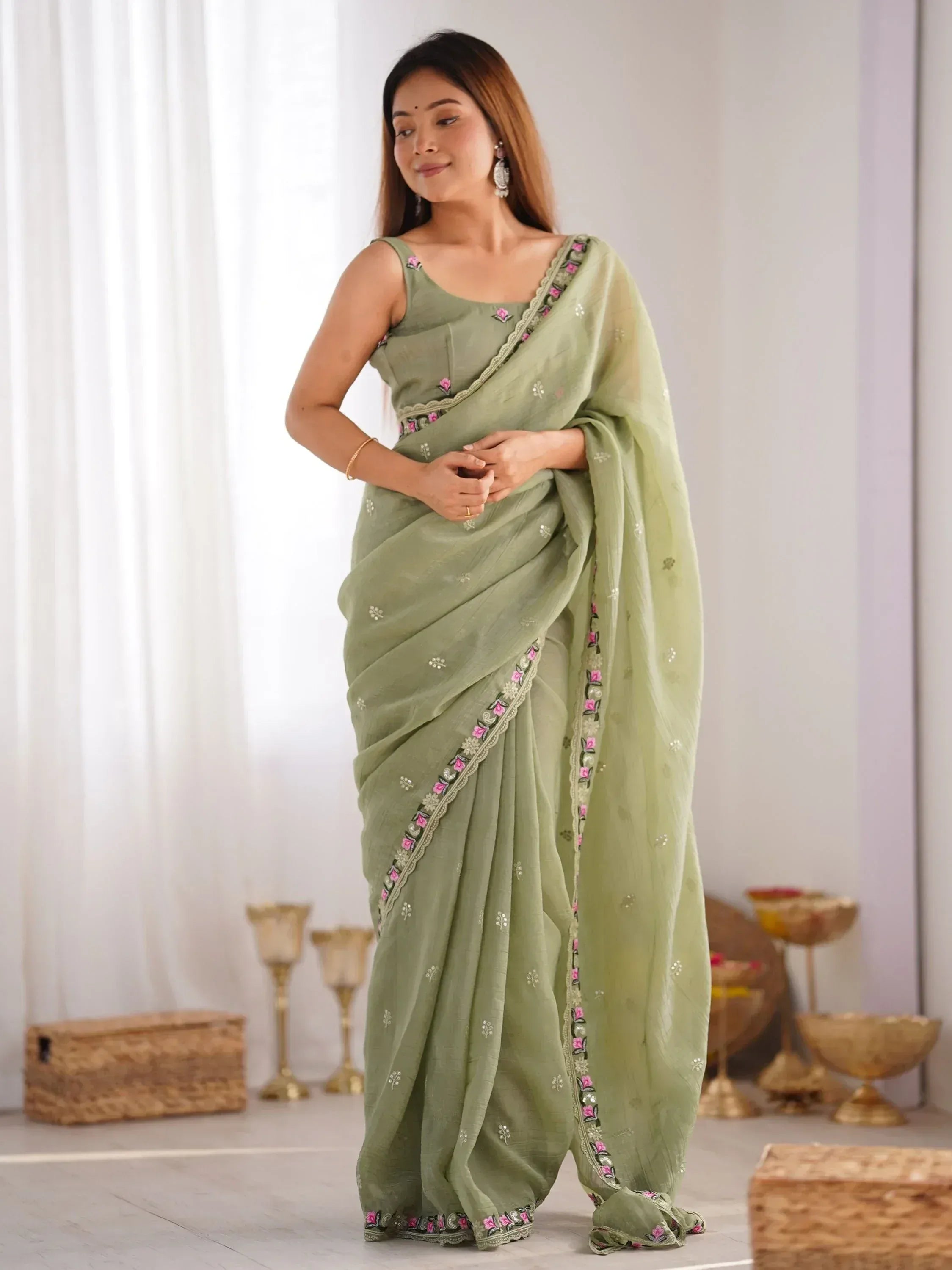 Mint green embroidered saree with floral border, perfect for Indian ethnic wear occasions