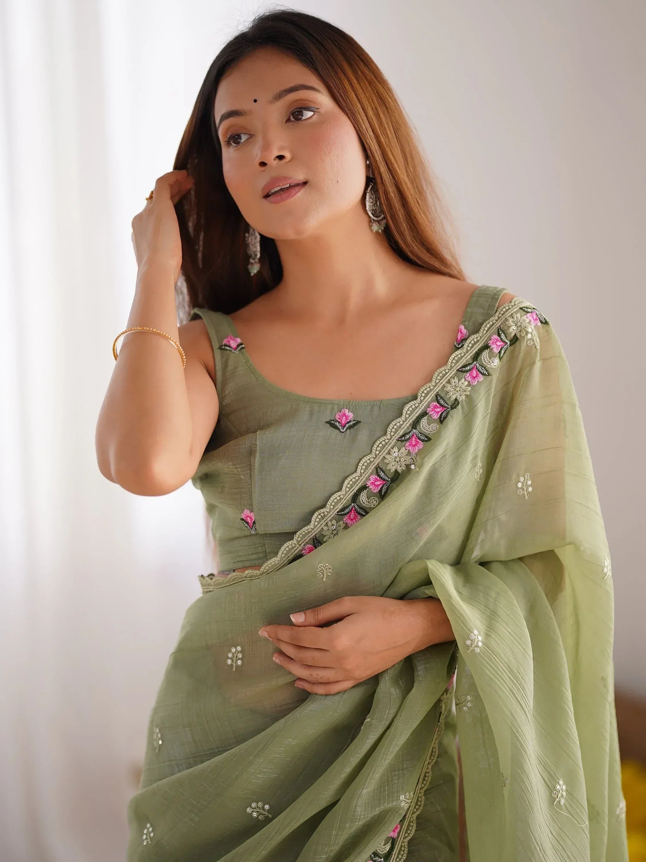 Olive green embroidered saree with floral detailing, perfect for Indian ethnic wear occasions.