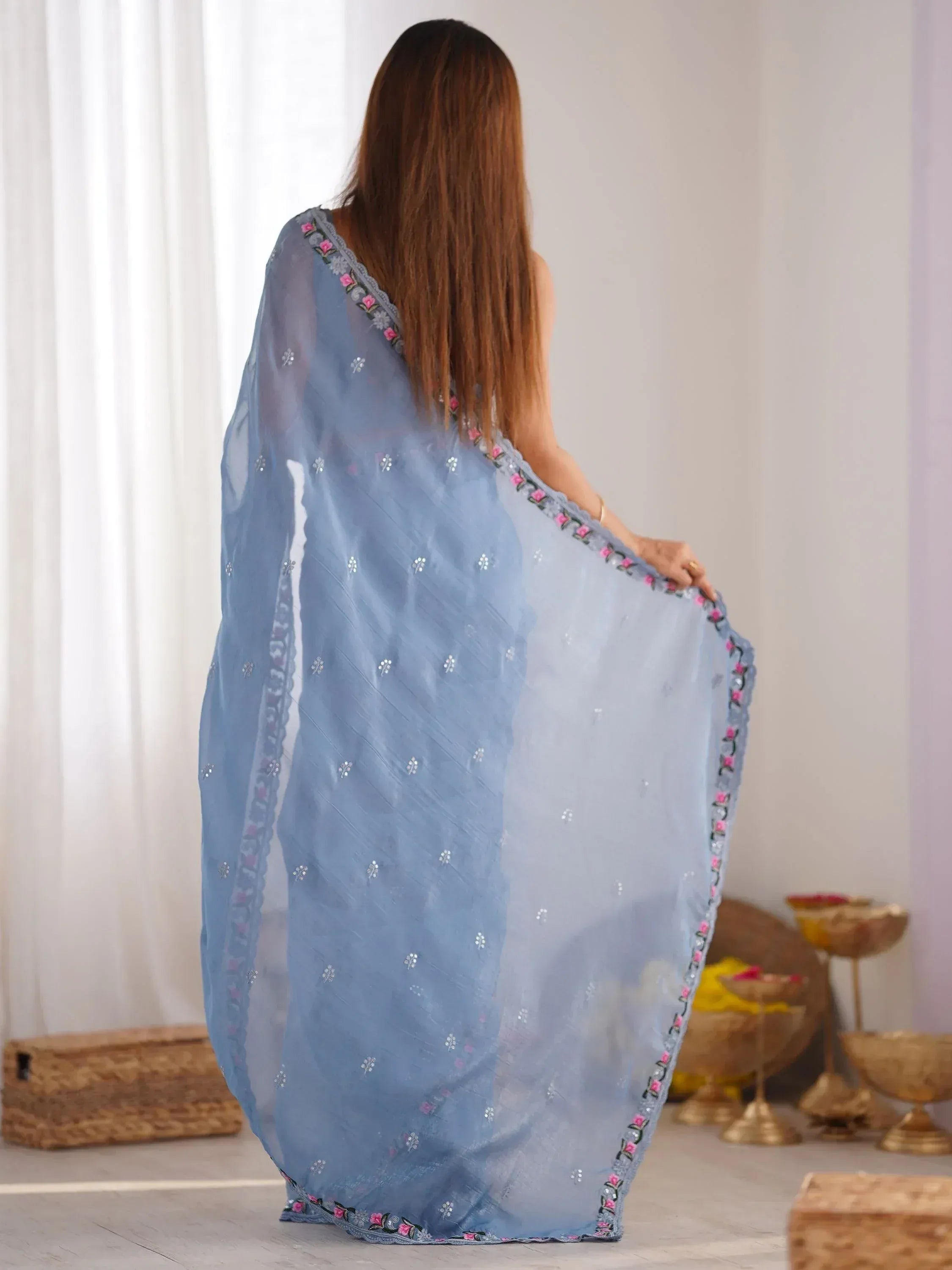 Light blue embroidered saree with floral border, showcased from back view for ethnic wear styling