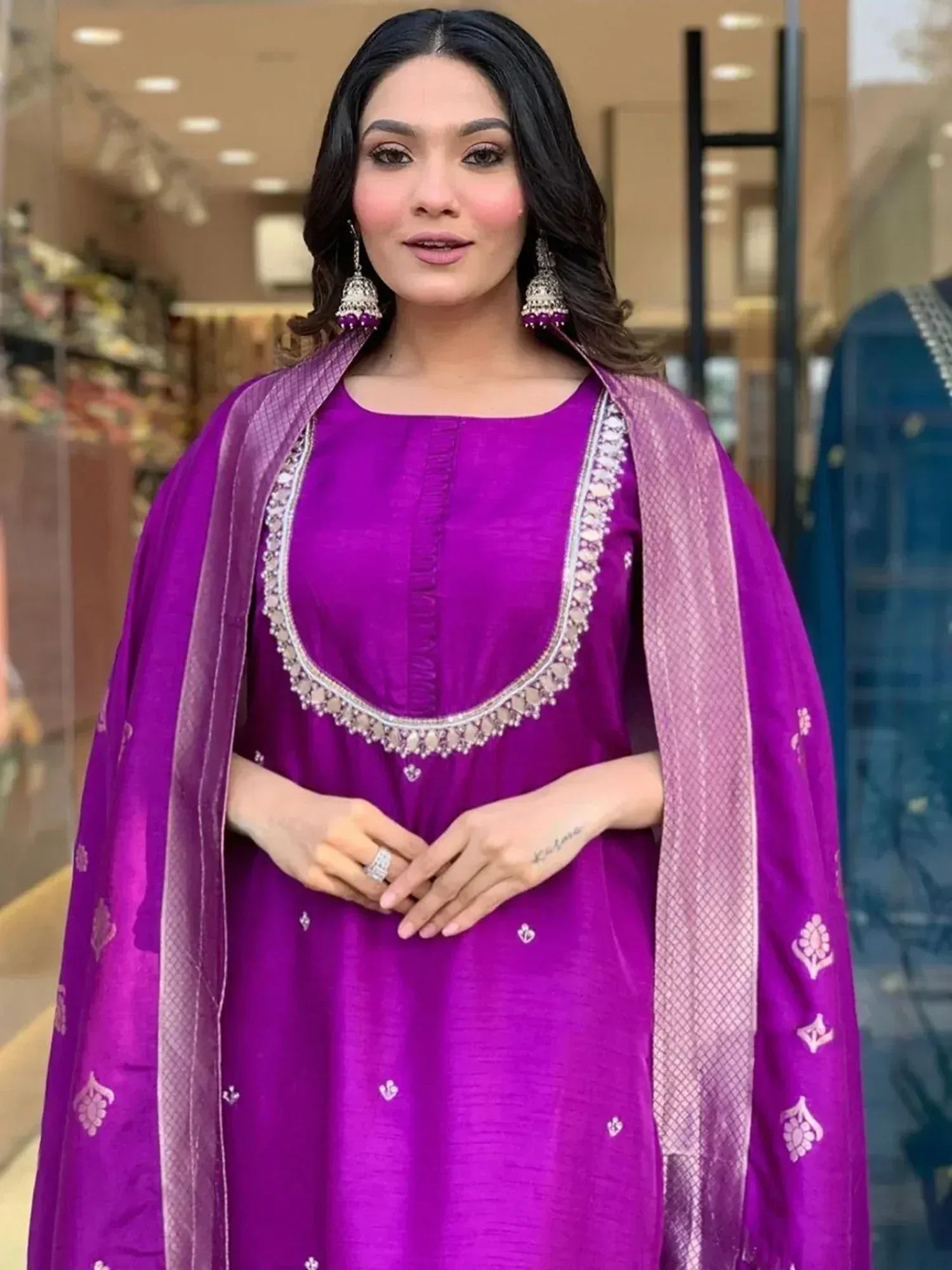 Purple ethnic kurta with embroidered neckline and matching dupatta, styled with jhumka earrings for festive occasions