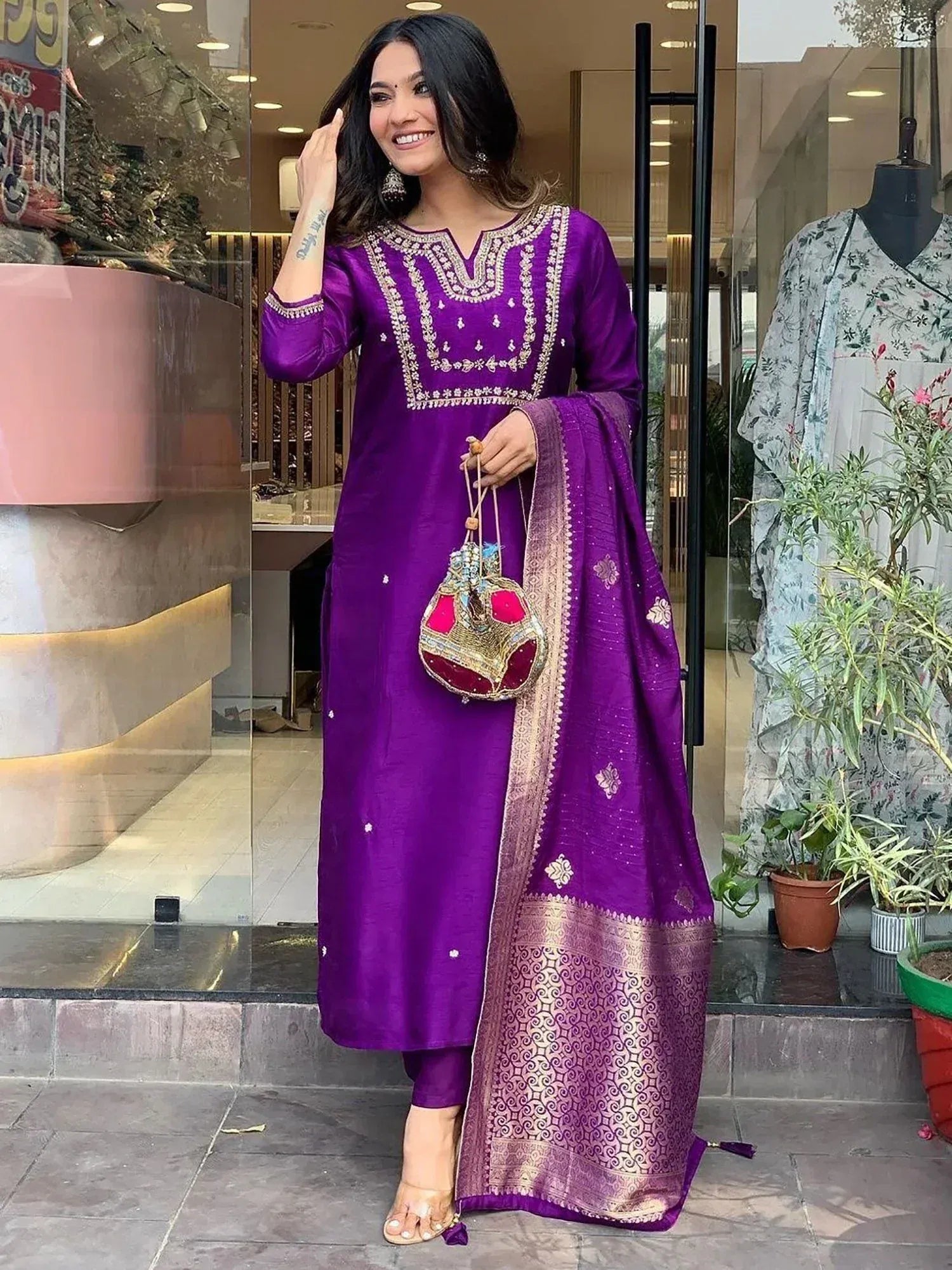 Purple embroidered ethnic kurti with golden dupatta and matching accessories