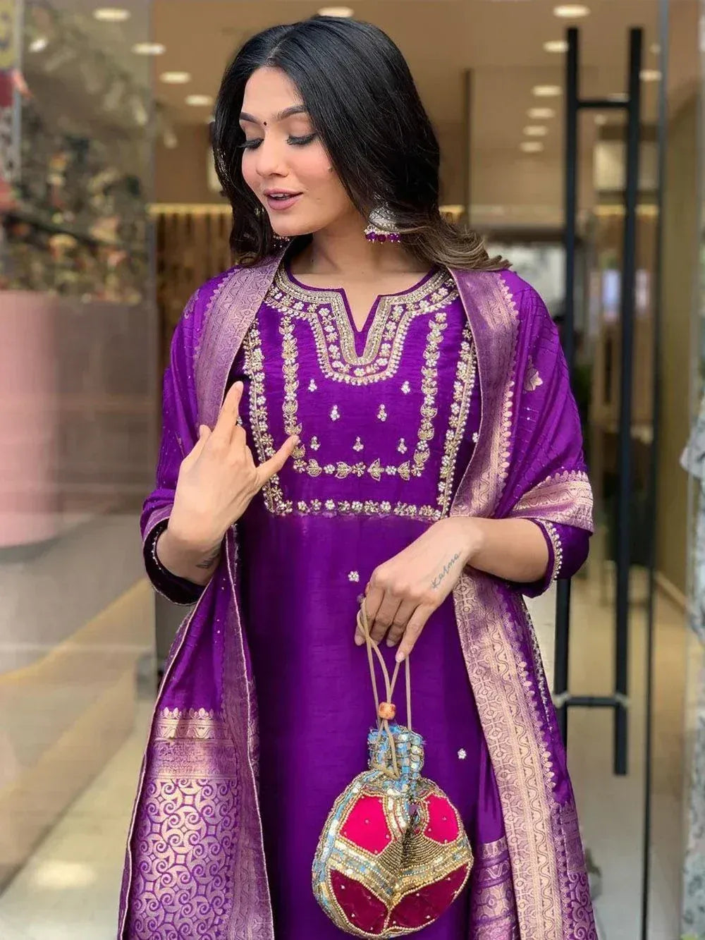 Purple embroidered ethnic kurti with matching dupatta and potli bag, perfect for Indian occasions