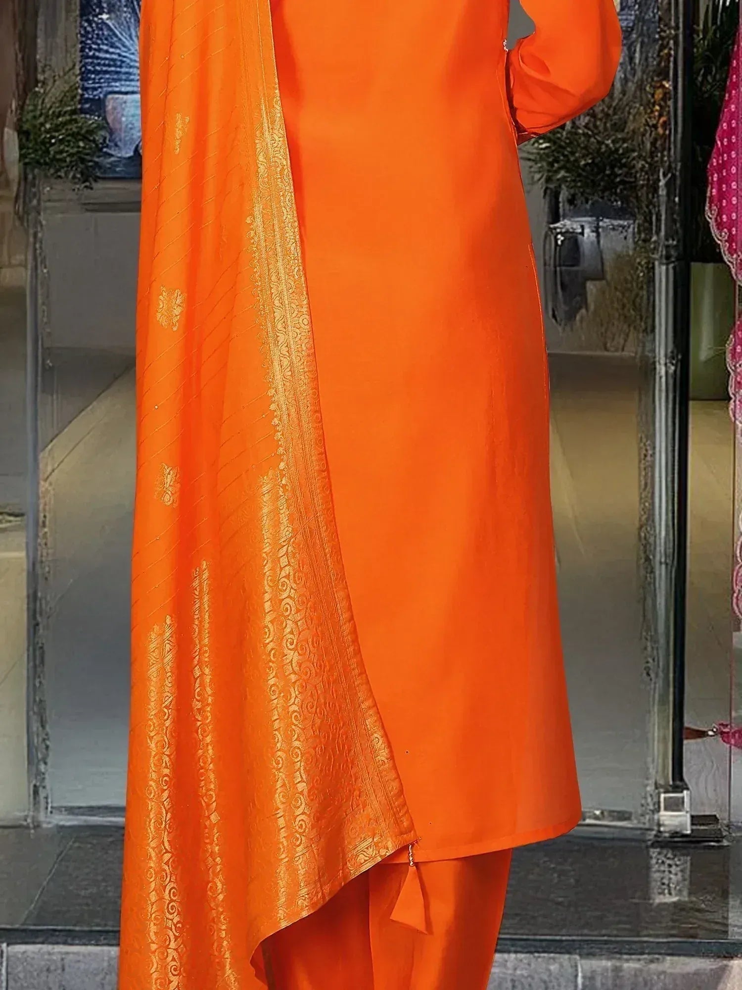 Vibrant orange salwar kameez with gold embroidered dupatta, perfect for Indian ethnic occasions