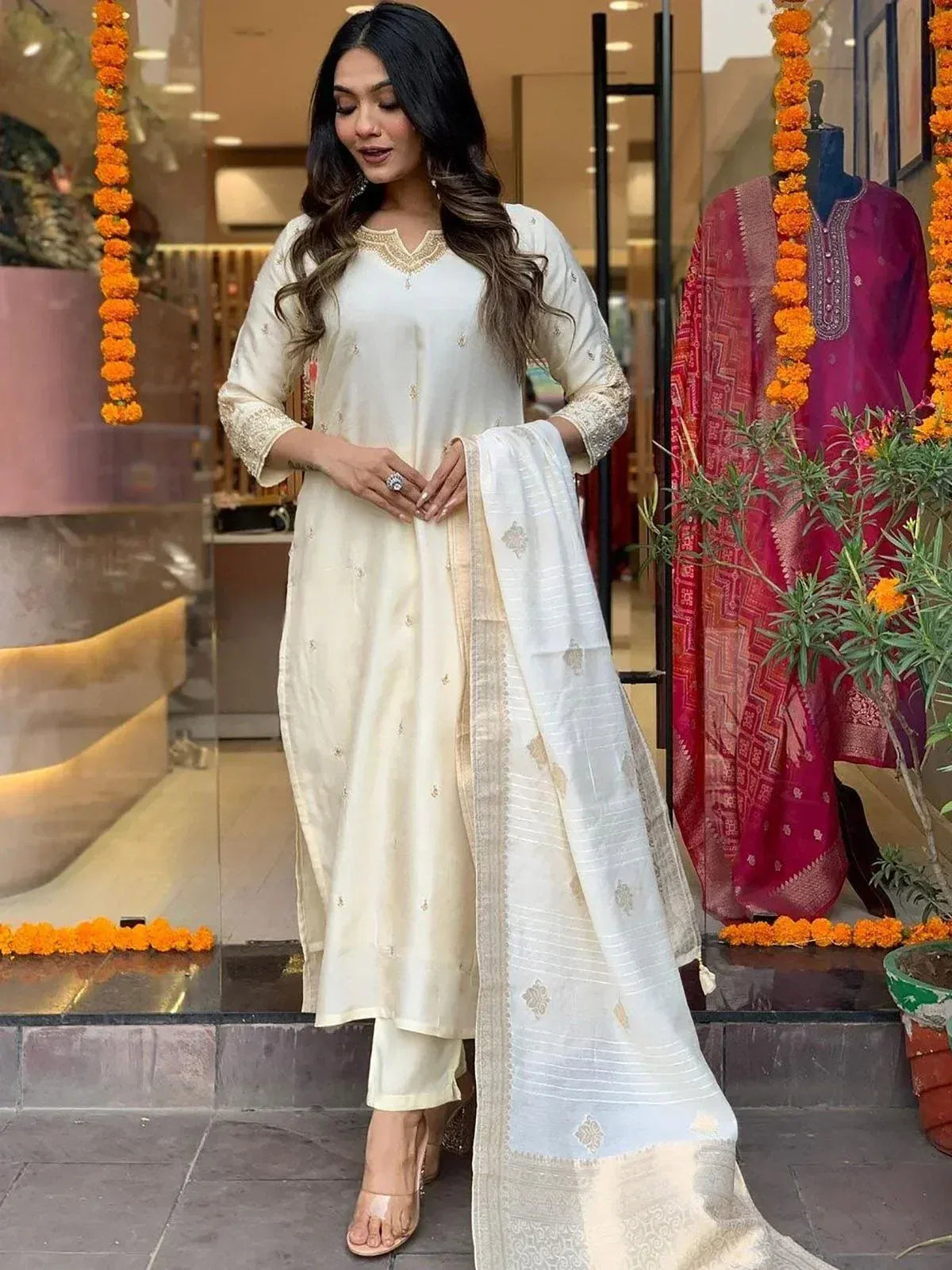 Elegant cream salwar kameez with gold embroidery, paired with matching dupatta, perfect for festive occasions.