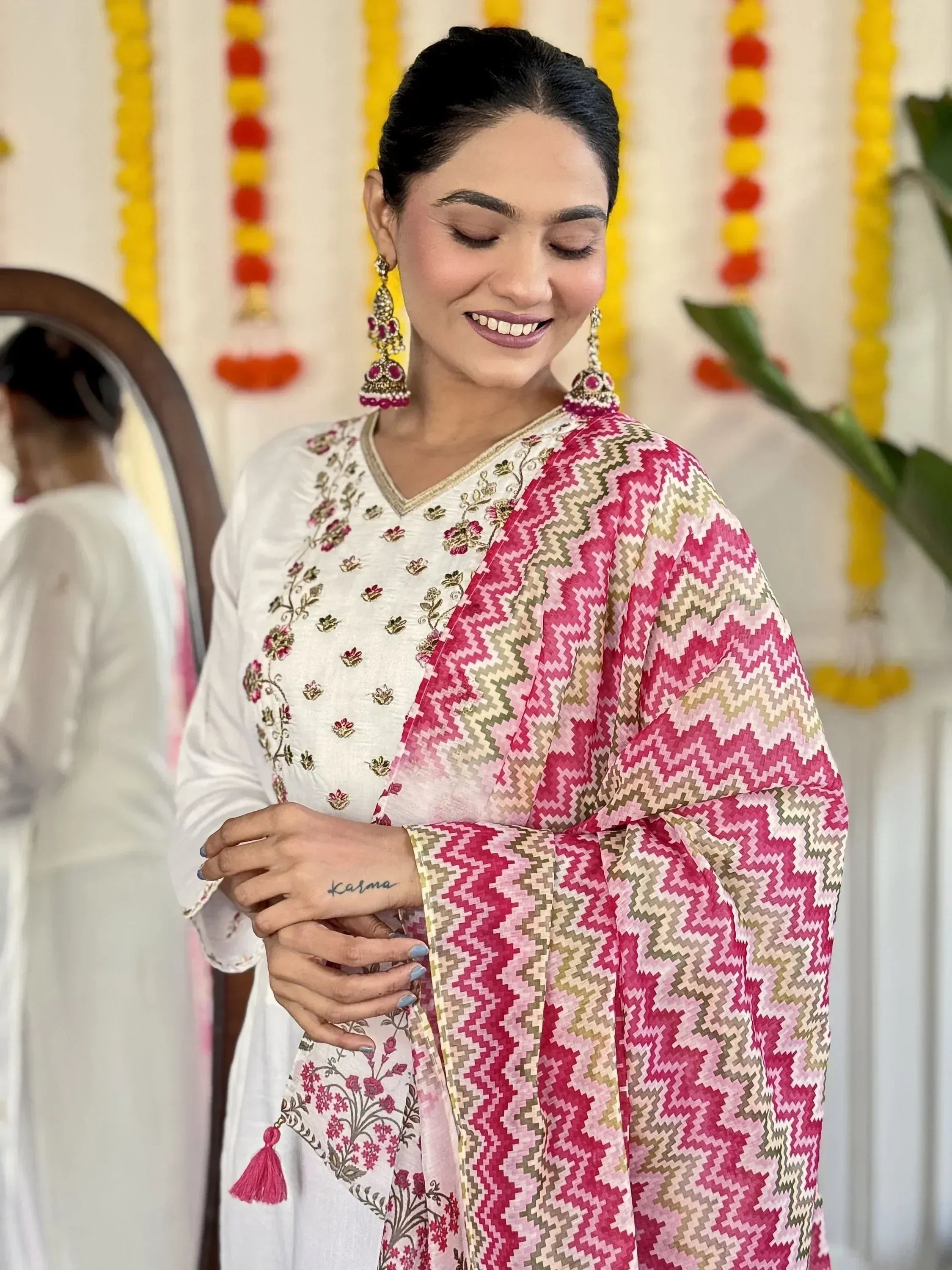Woman in white floral kurta with pink geometric dupatta, traditional Indian ethnic wear