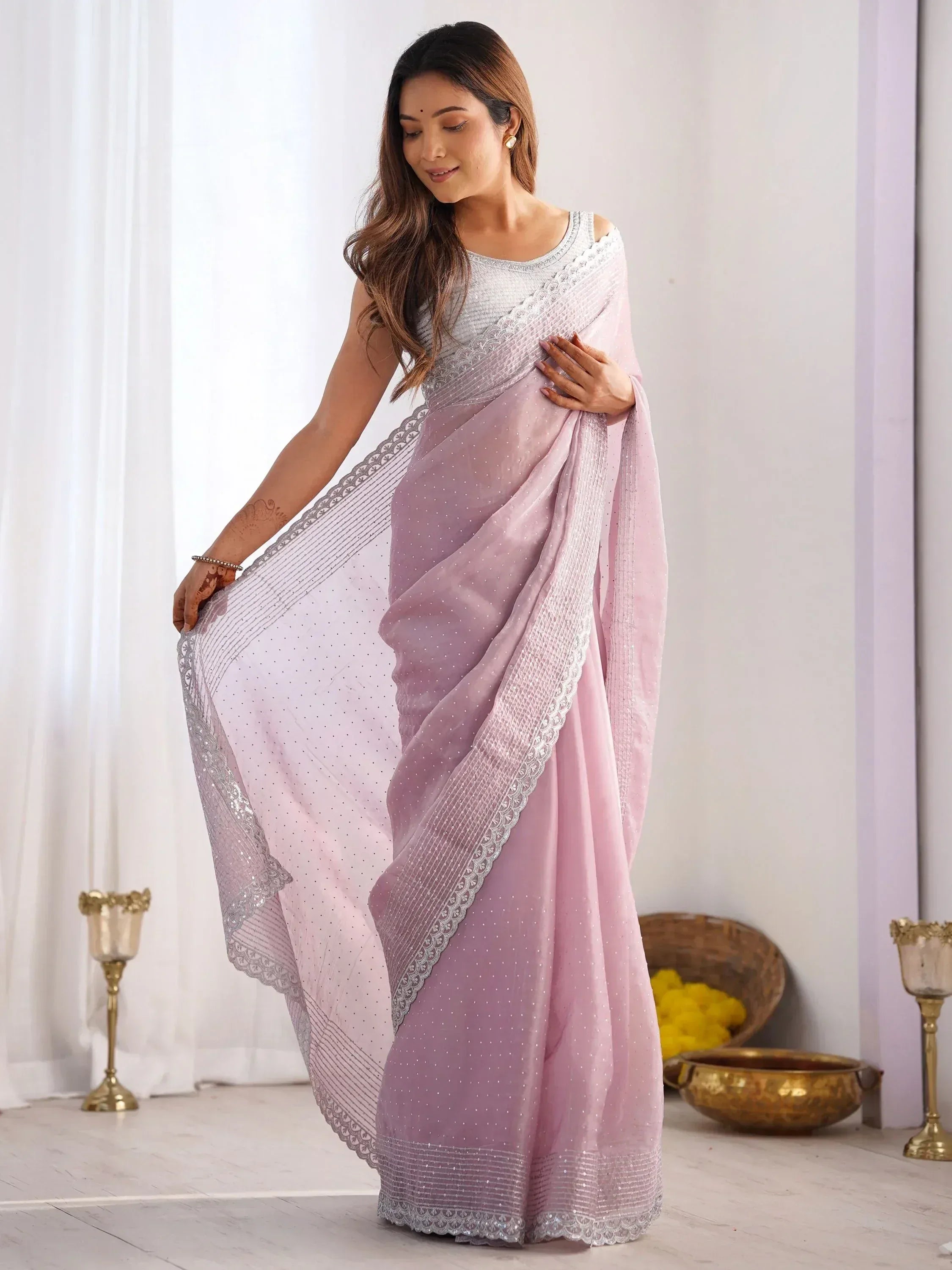 Elegant lavender saree with silver embroidery and sequins, paired with a matching blouse for Indian ethnic wear