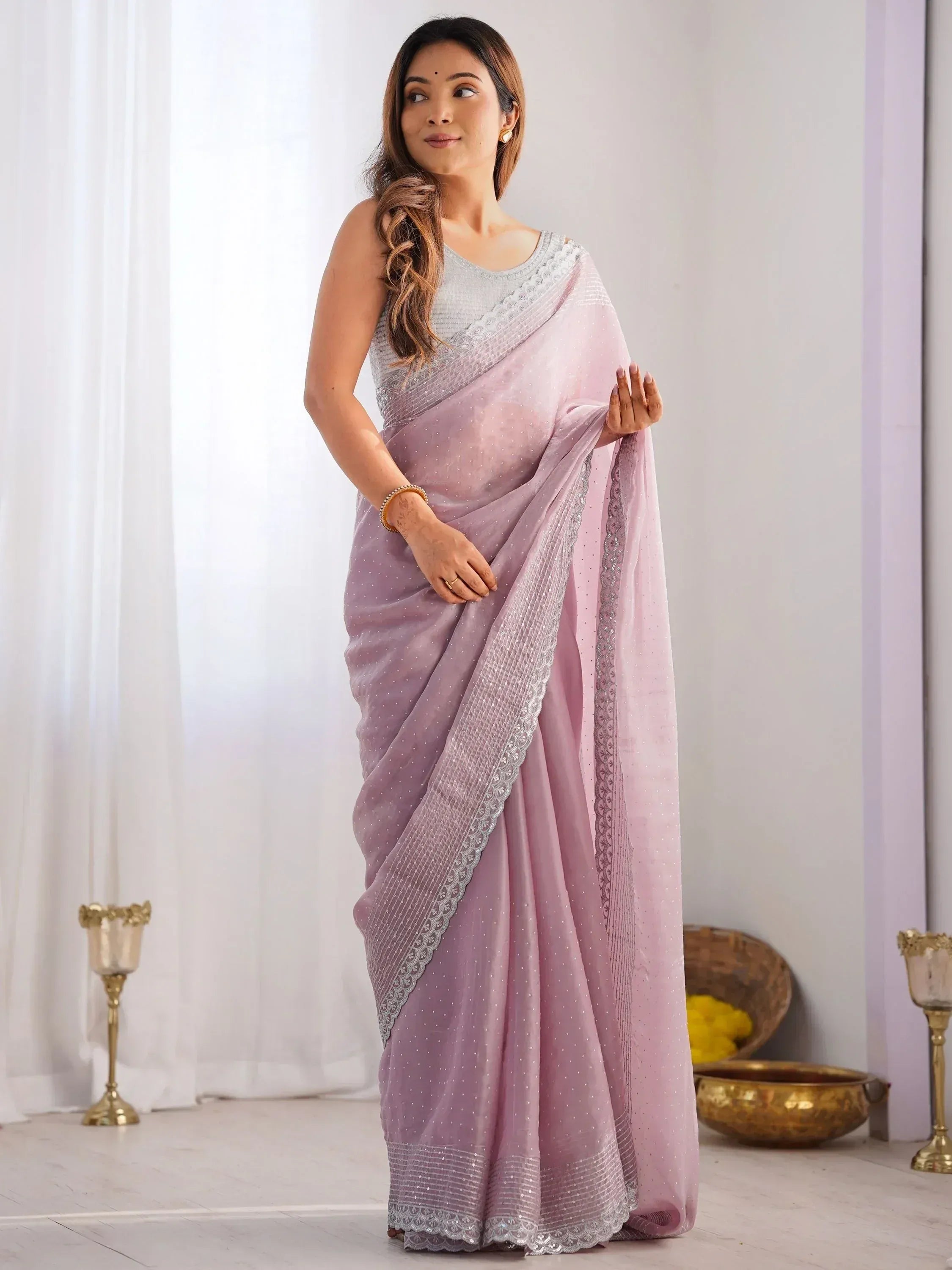 Elegant lavender saree with silver embroidery and lace border, perfect for Indian ethnic occasions