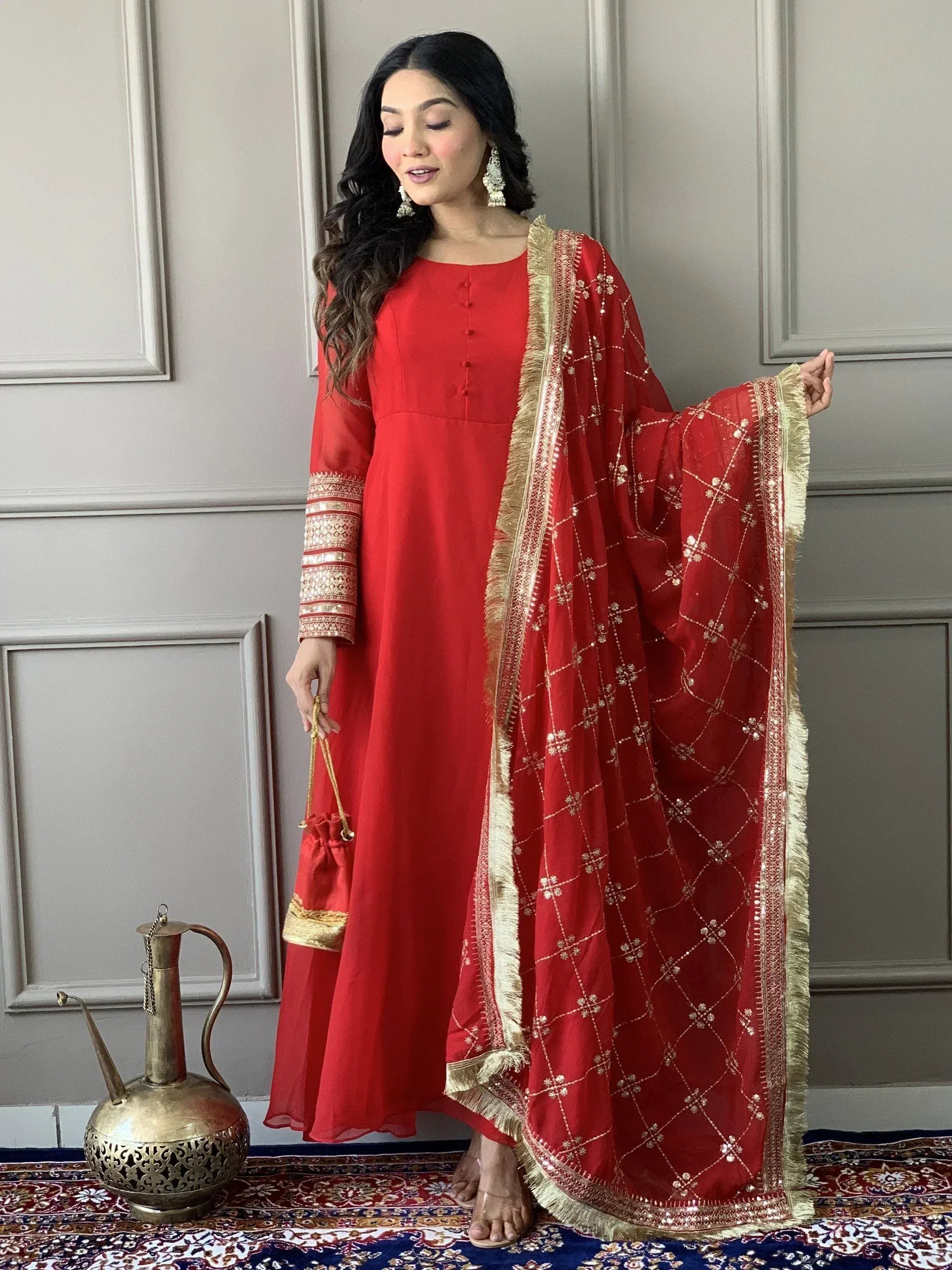 Red ethnic anarkali suit with gold embroidery and matching dupatta, perfect for Indian weddings and festive occasions.