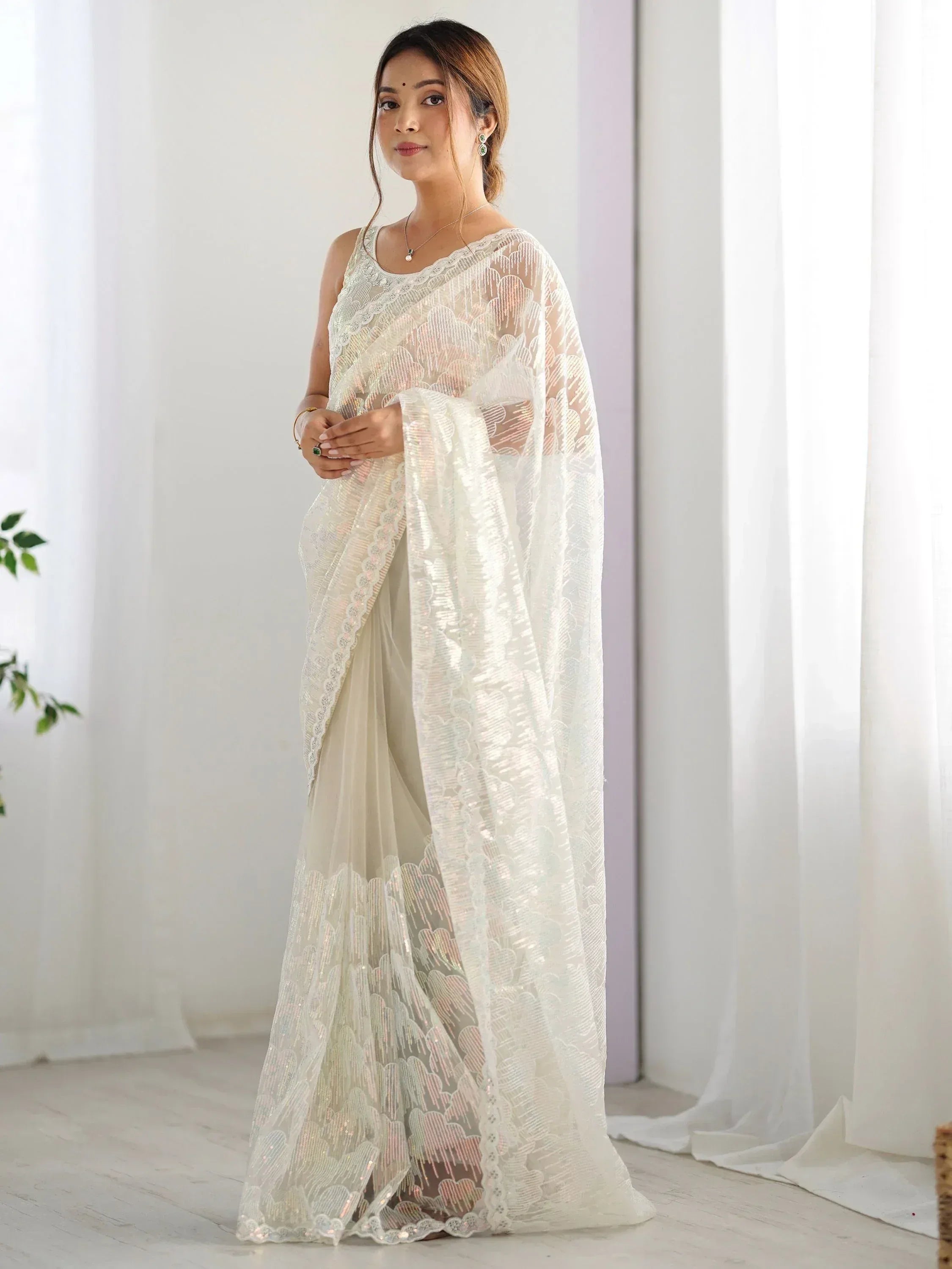 Elegant white embroidered saree with sequin detailing, perfect for Indian ethnic occasions