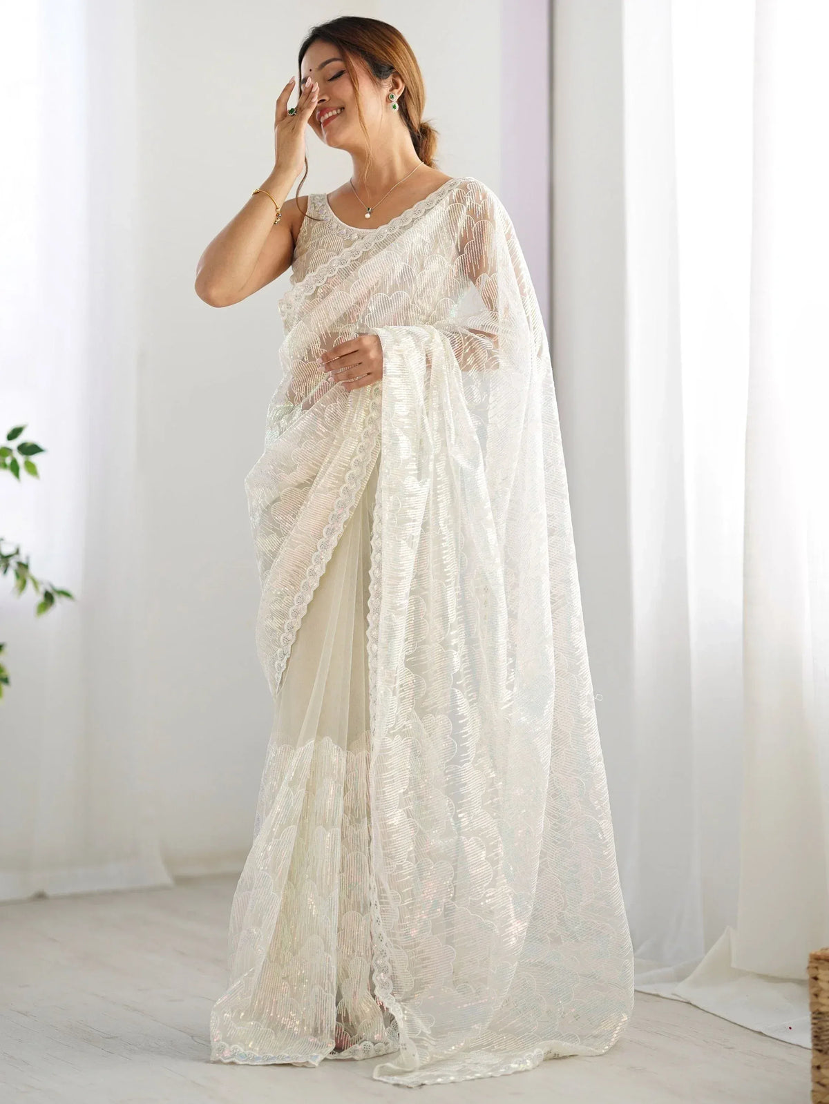 Elegant white embroidered saree with lace detailing, perfect for Indian ethnic wear occasions.